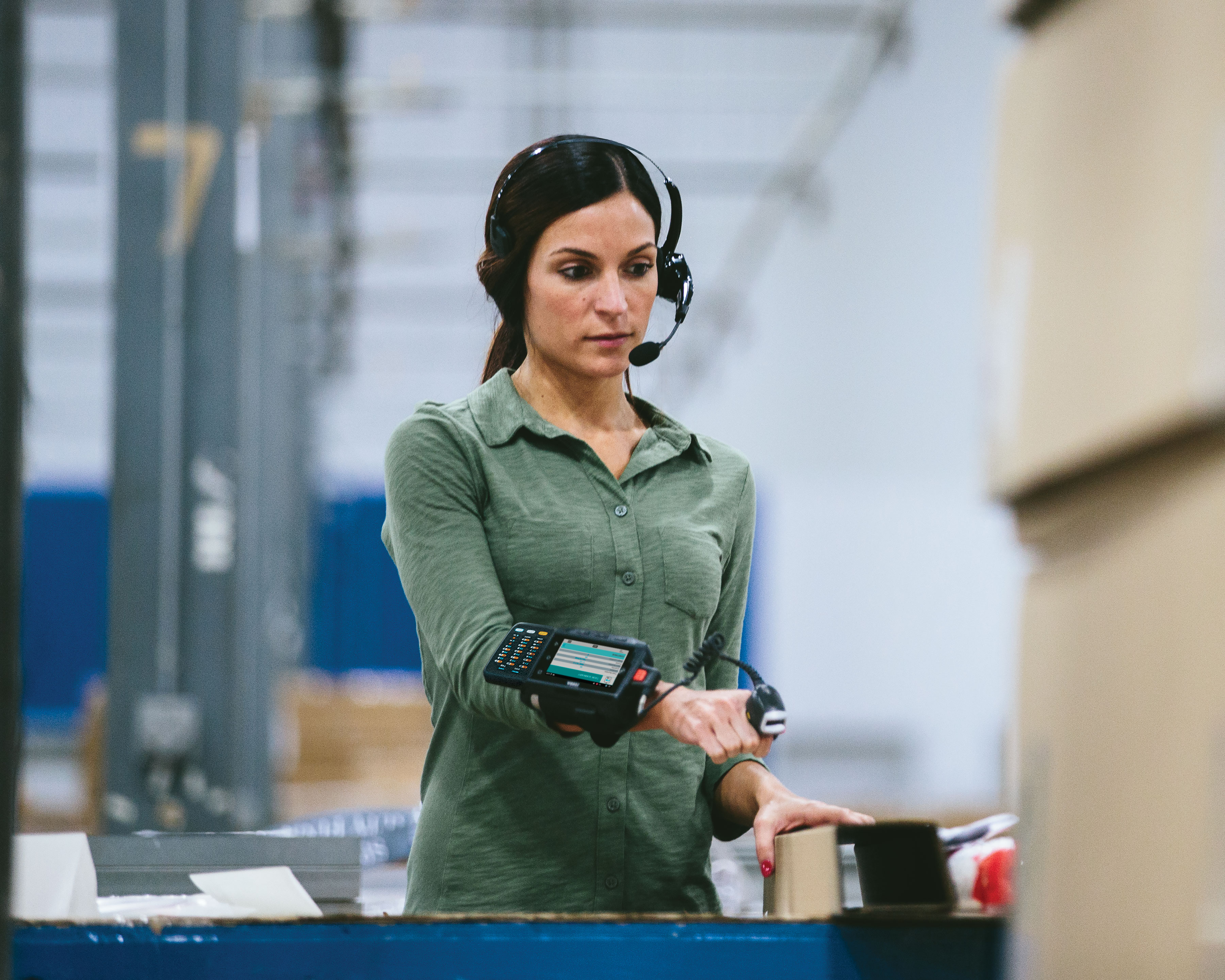 Worker uses Zebra HS3100 Bluetooth headset for warehouse sorting