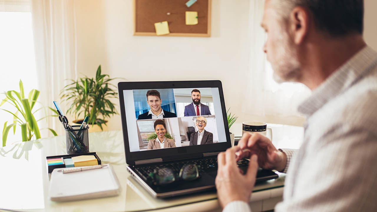 Man working from home having online group videoconference on laptop