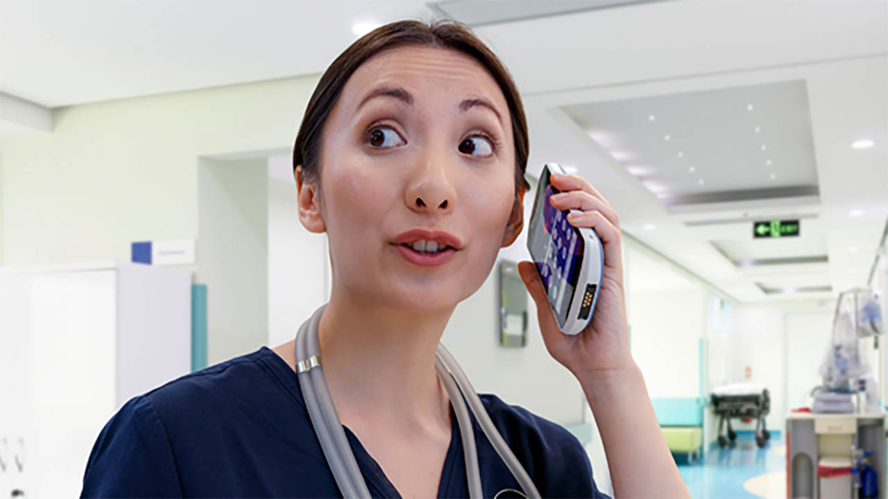 A nurse talks on a Zebra clinical smartphone