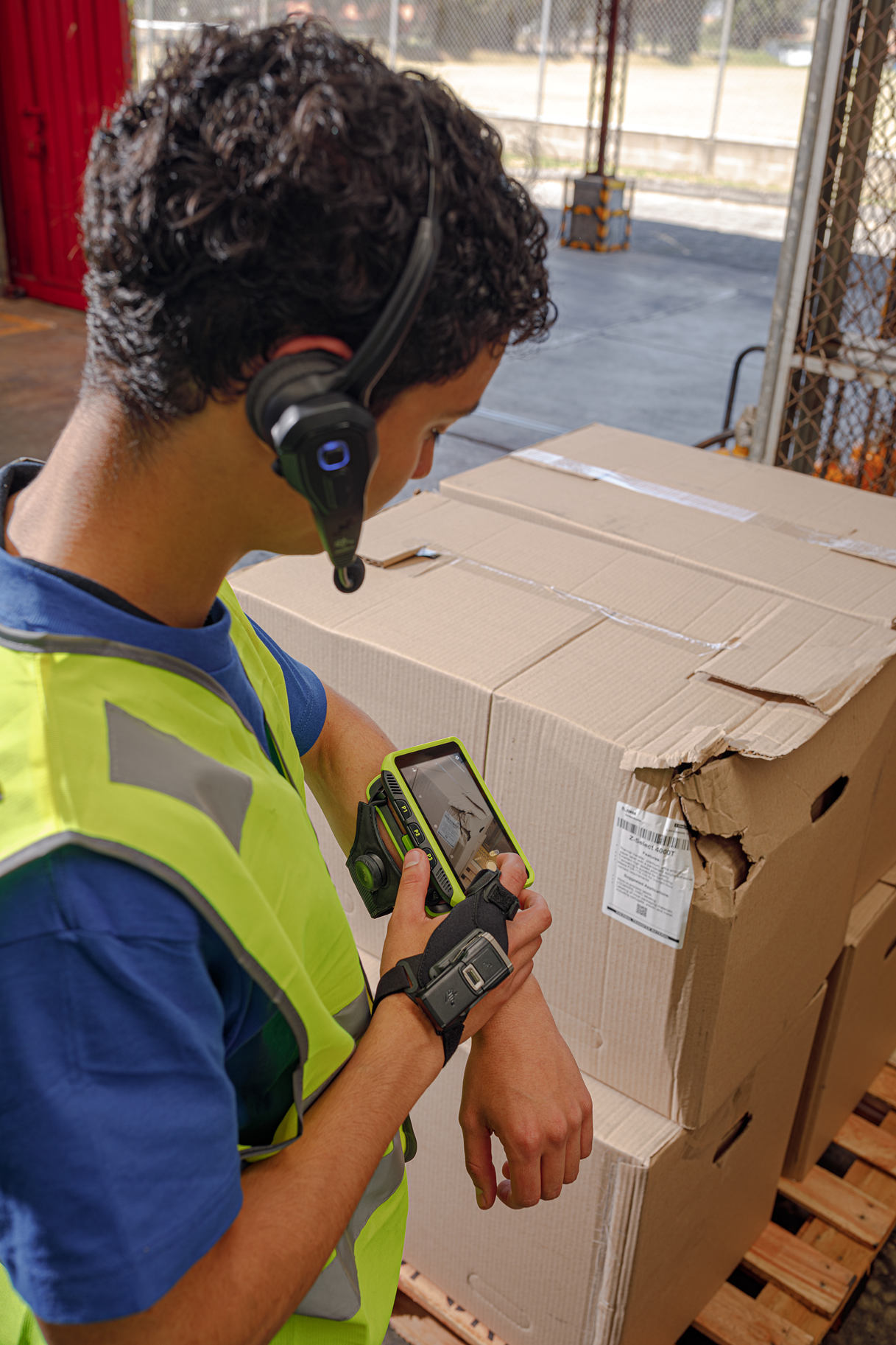 Warehouse associate wearing a Zebra HS3100 headset while receiving stock hands-free