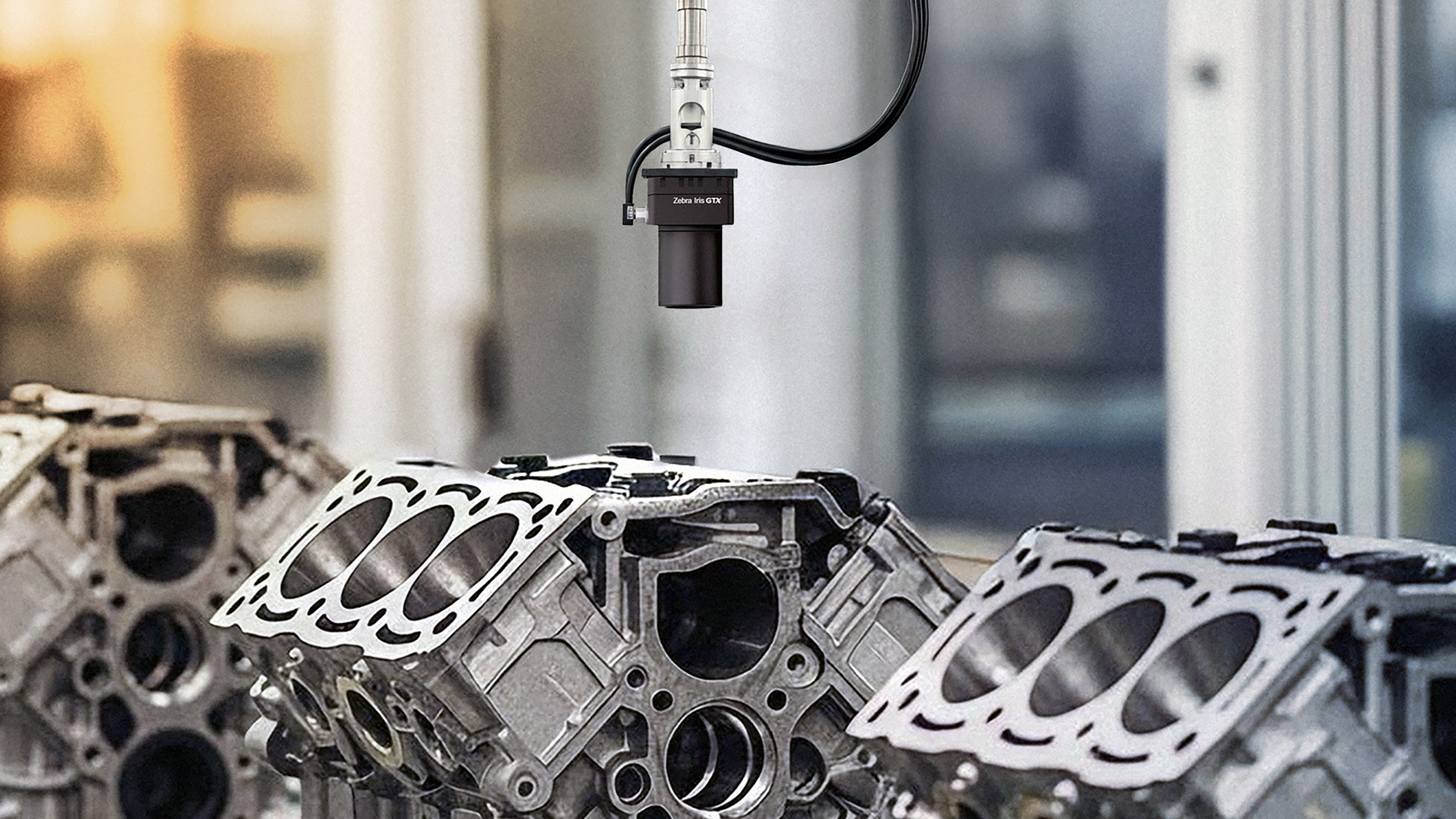 GTX machine vision industrial camera inspecting engine block surfaces on an automated manufacturing line. Image shows vision-guided quality control for dimensional accuracy and defect detection in automotive production.