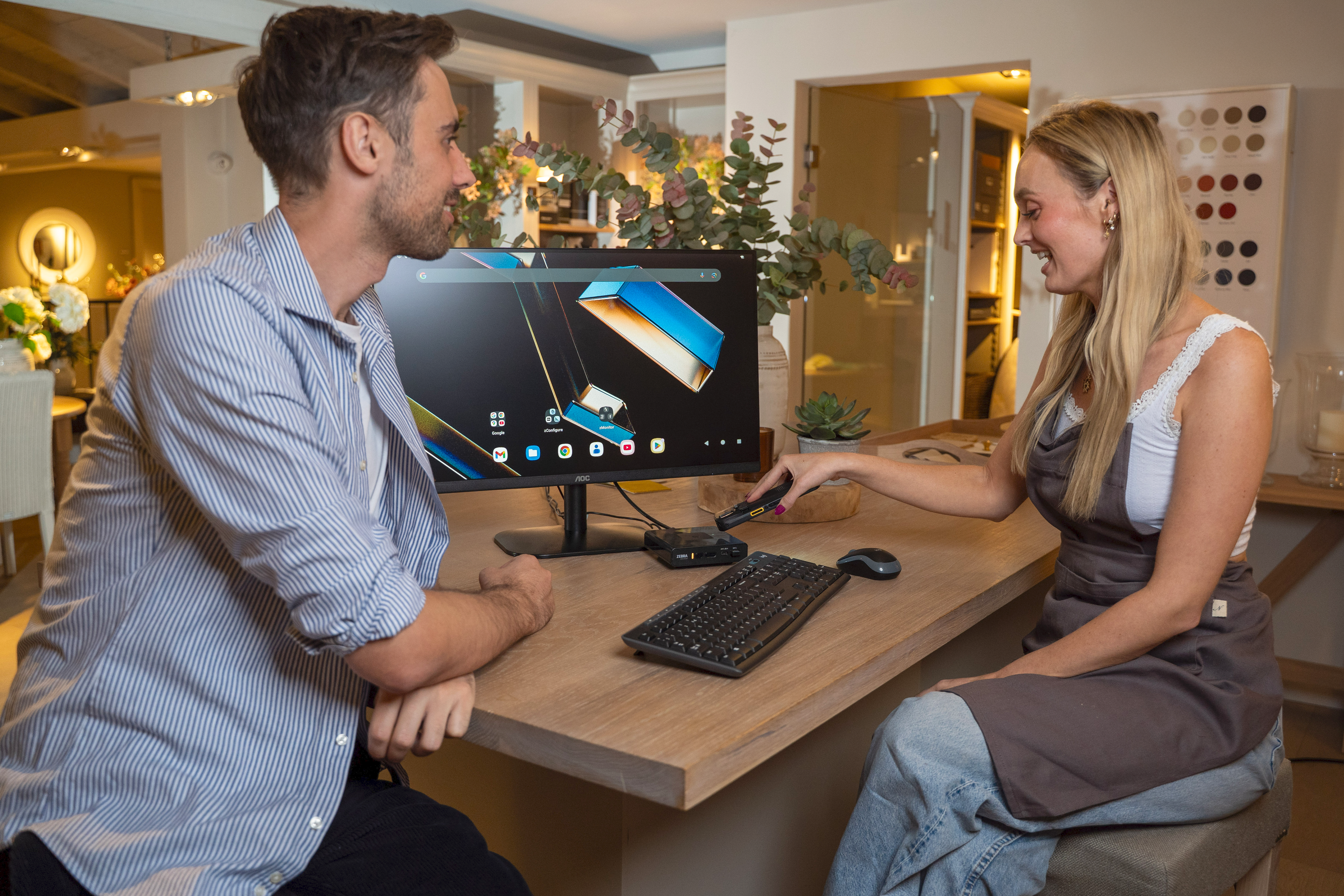 A retail associate tapping to connect TC53 to ZEC500 to enable casting mode