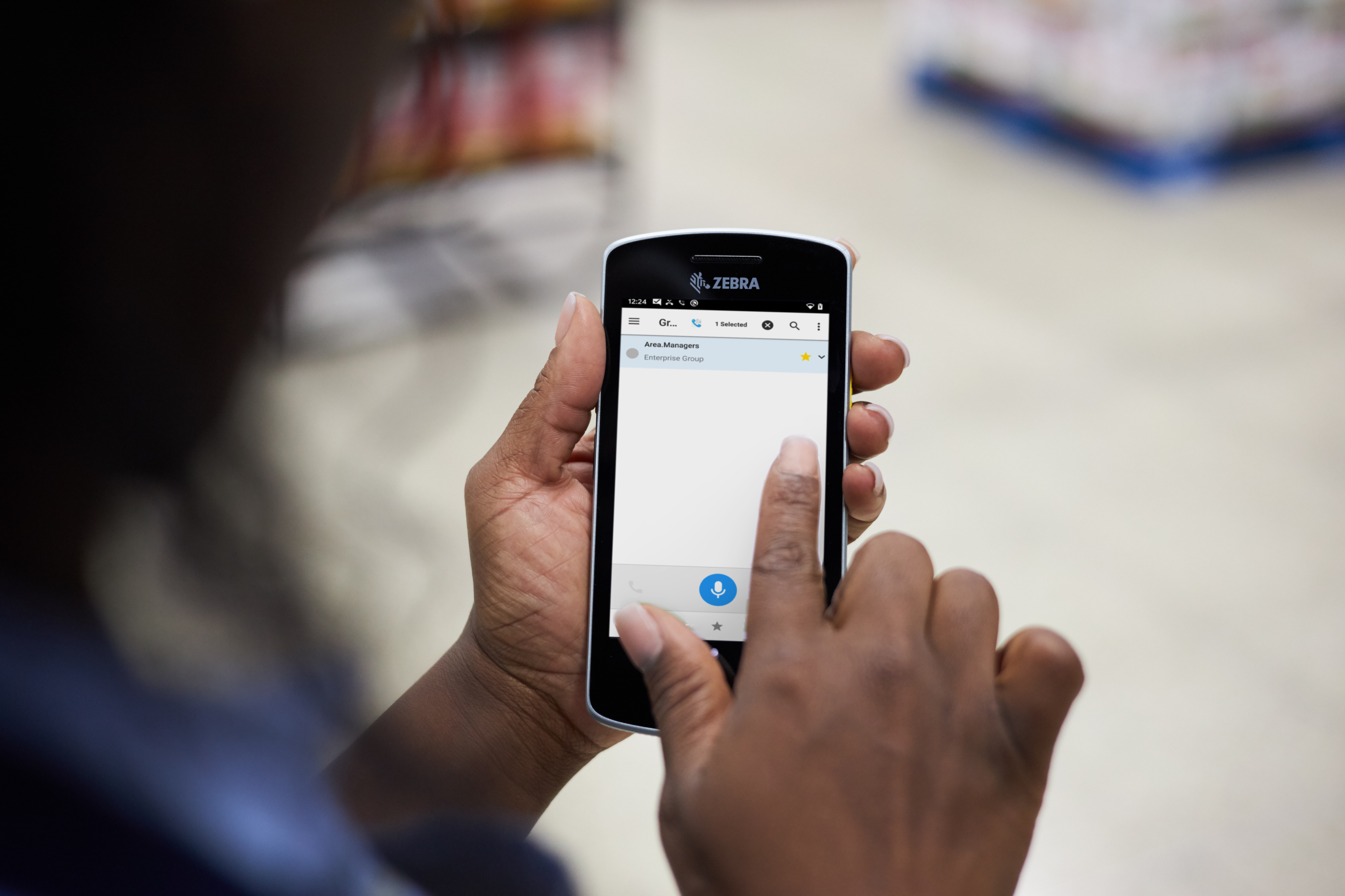 A retail worker communicates via PTT on their Zebra device