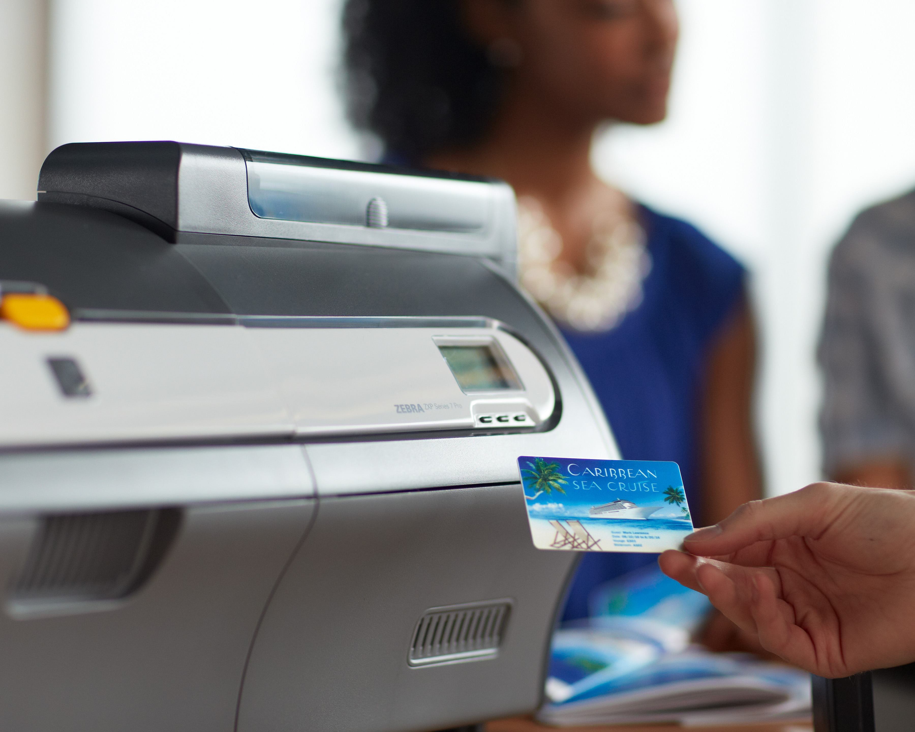 Zebra card printer prints out a Caribbean sea cruise membership card