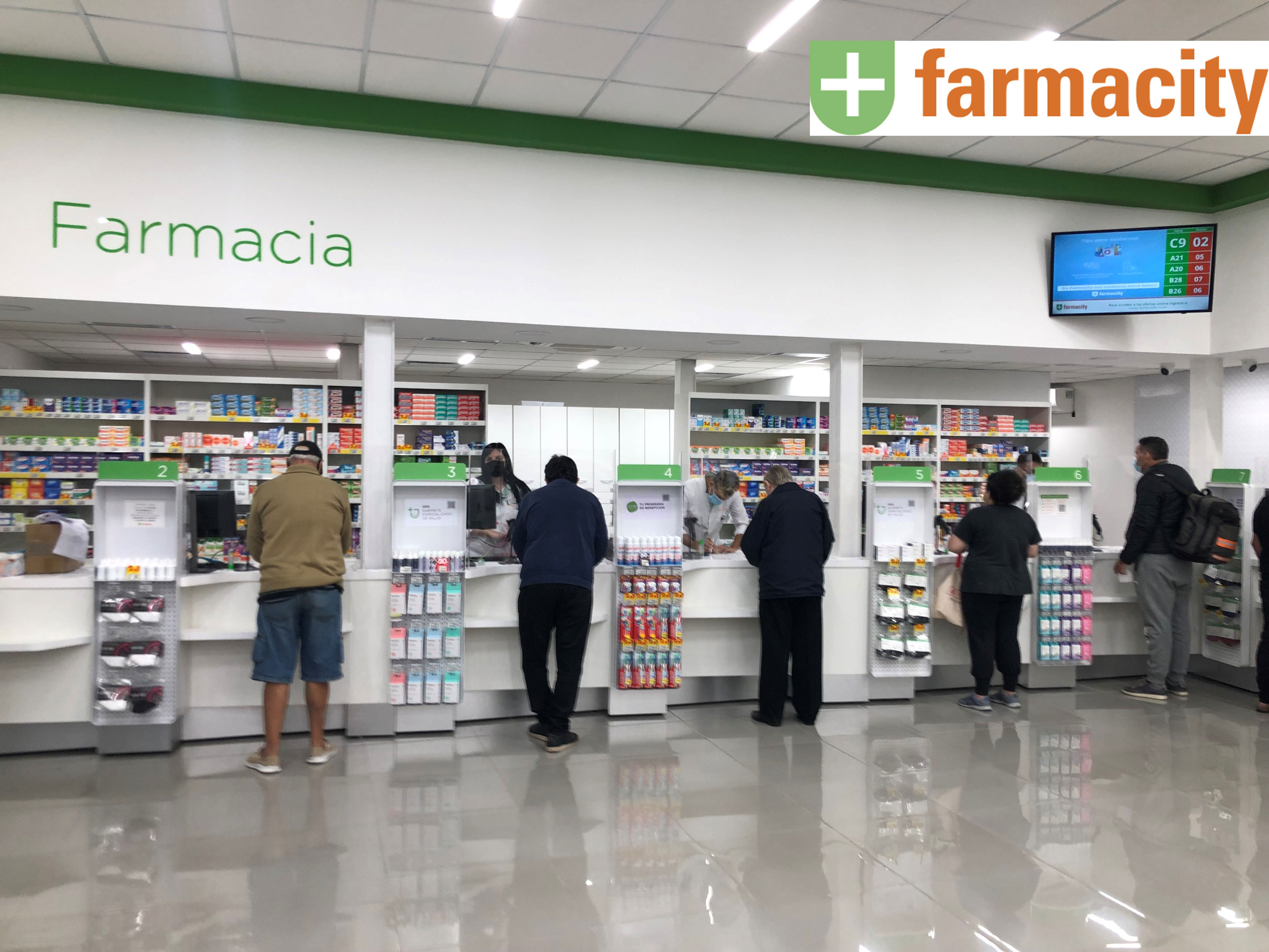 Farmacity counter with several customers.