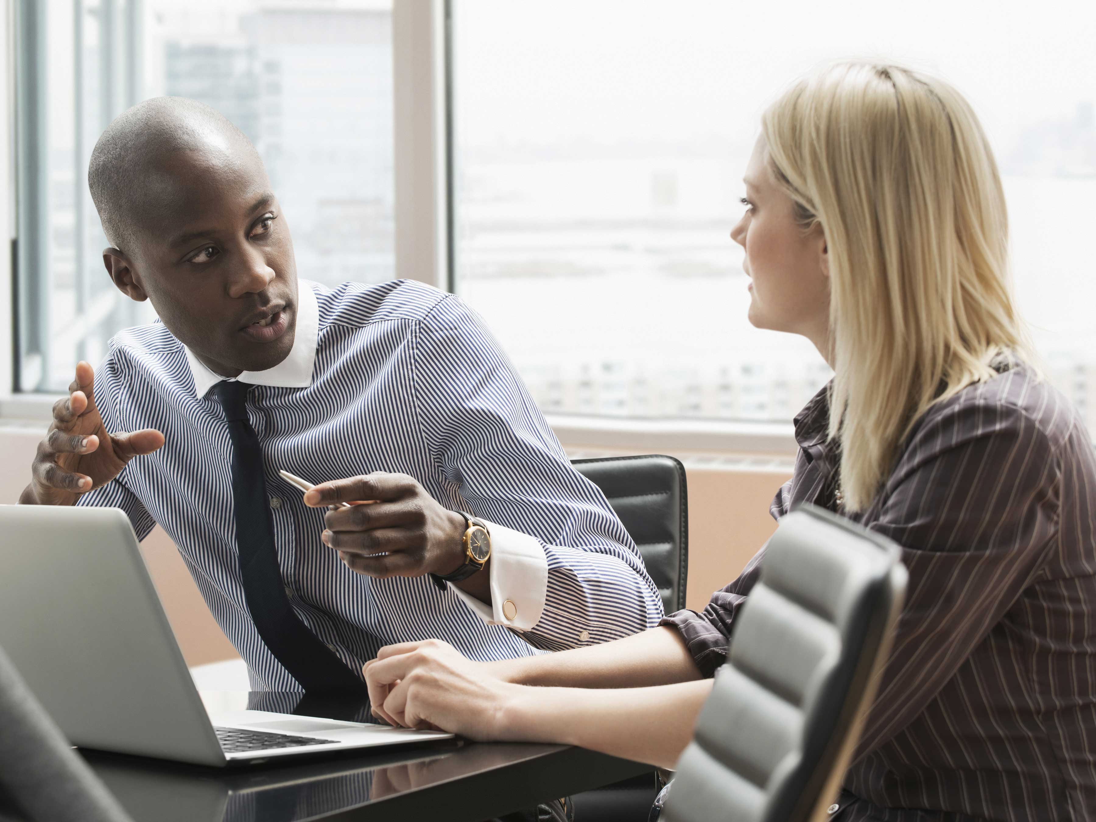 Two professionals collaborating in an office space