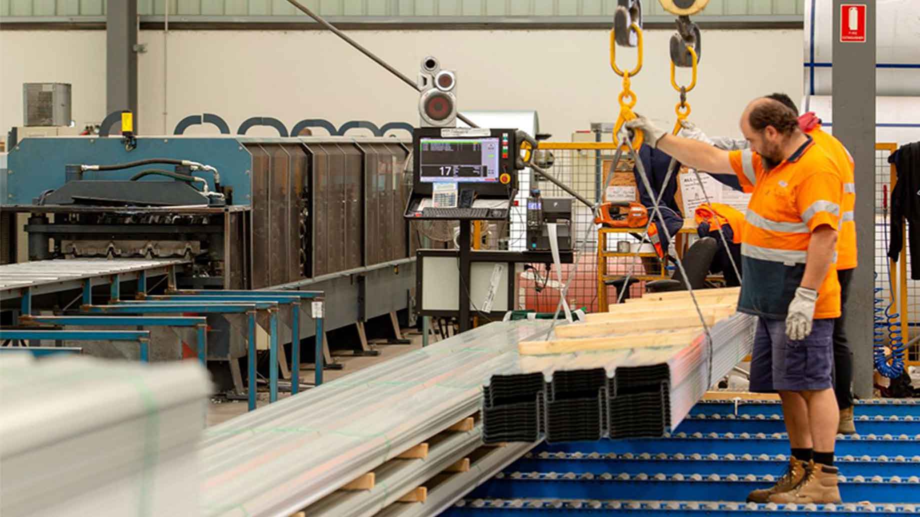 Employee handling steel bars