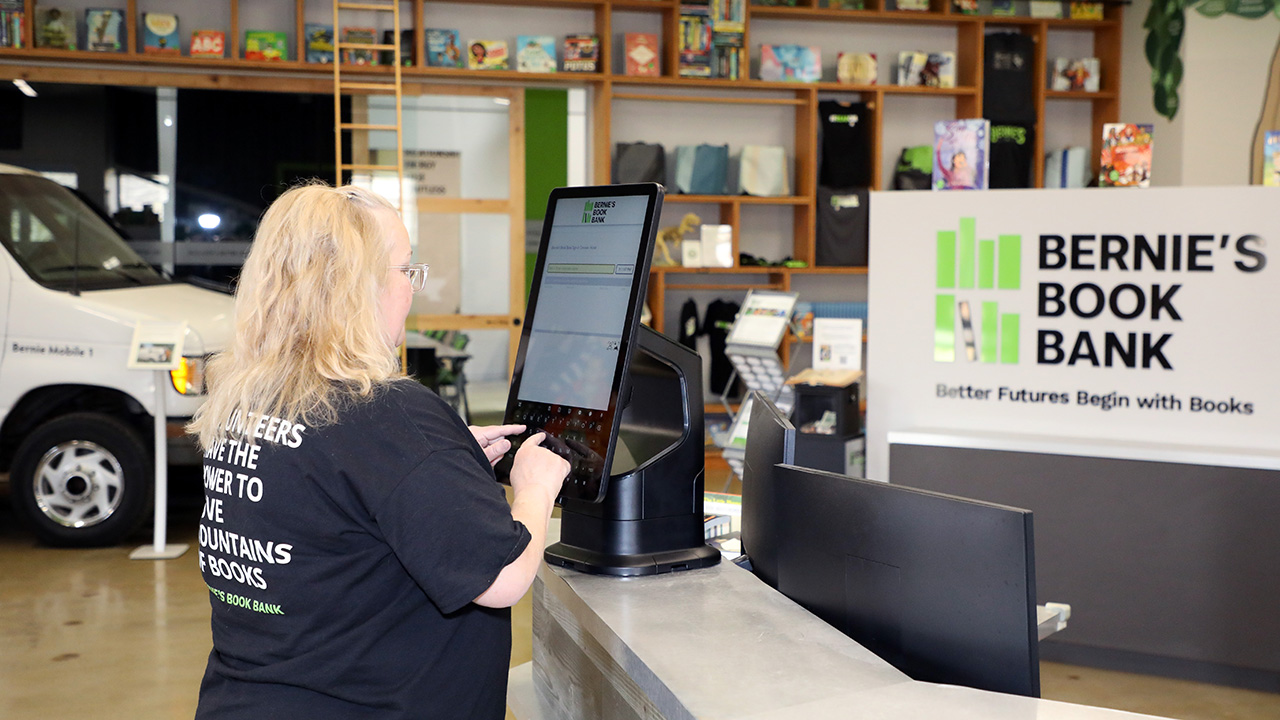 Bernie's Book Bank volunteer using Zebra's interactive kiosk