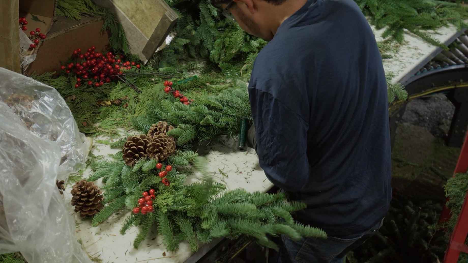 Employee arranging a Christmas wreath  