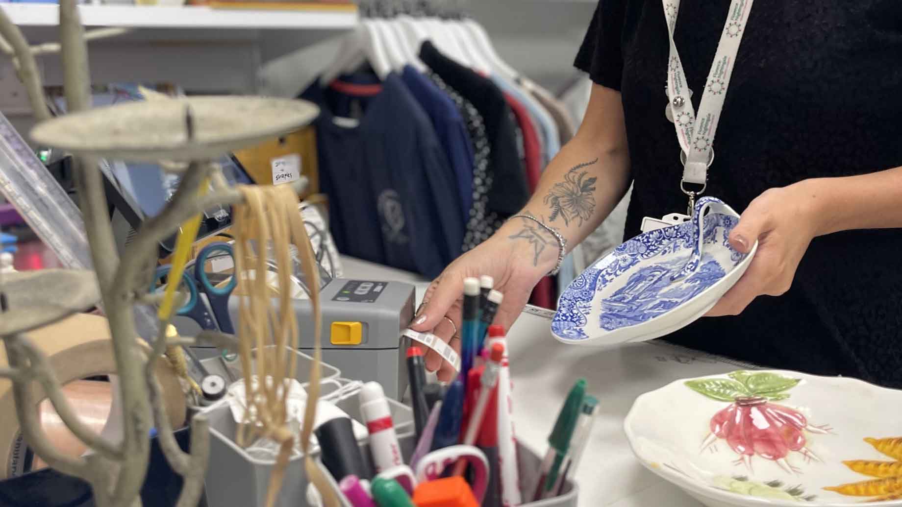 Employee using Zebra printer at a charity shop