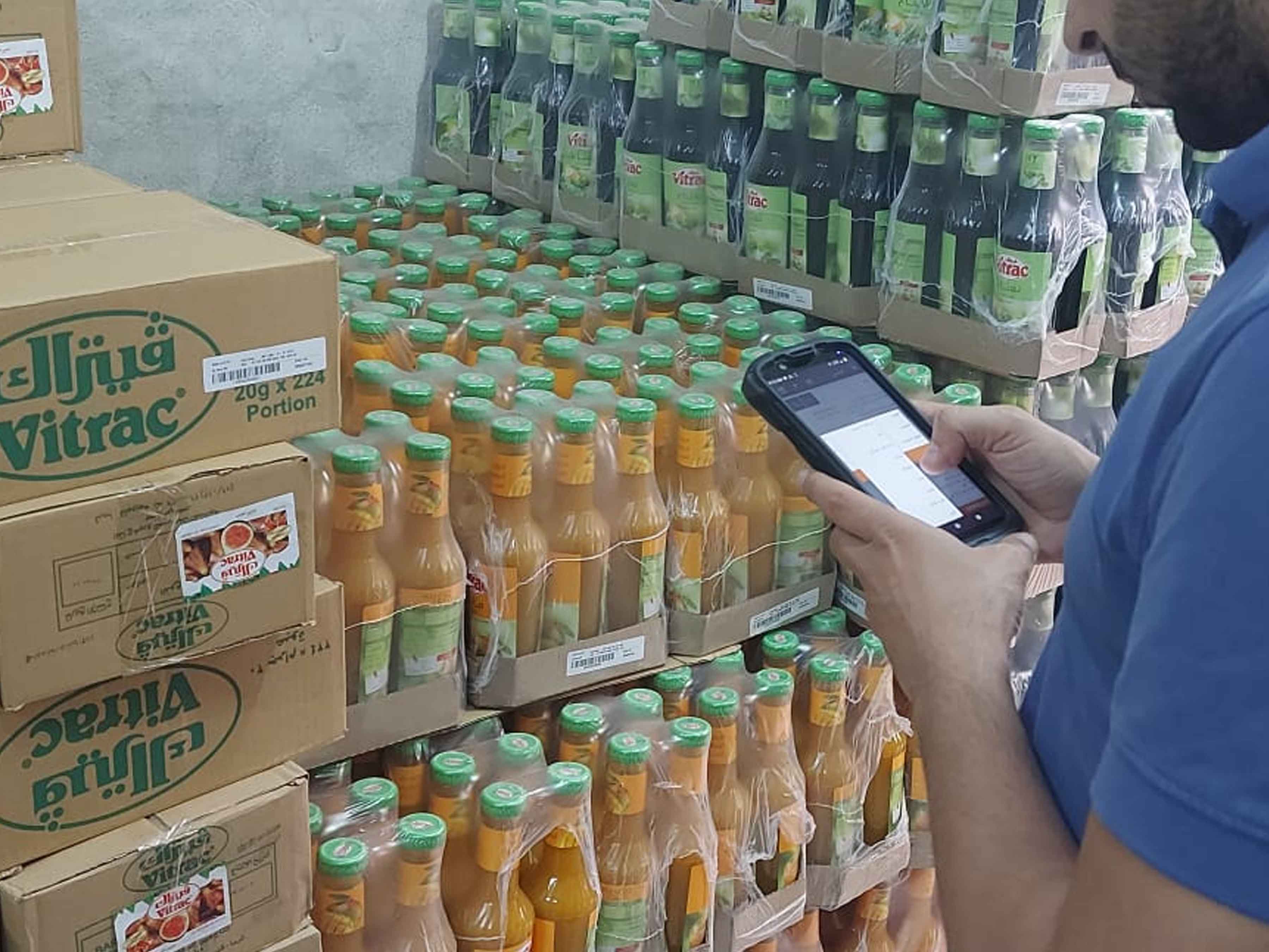 Worker using a handheld mobile computer for inventory