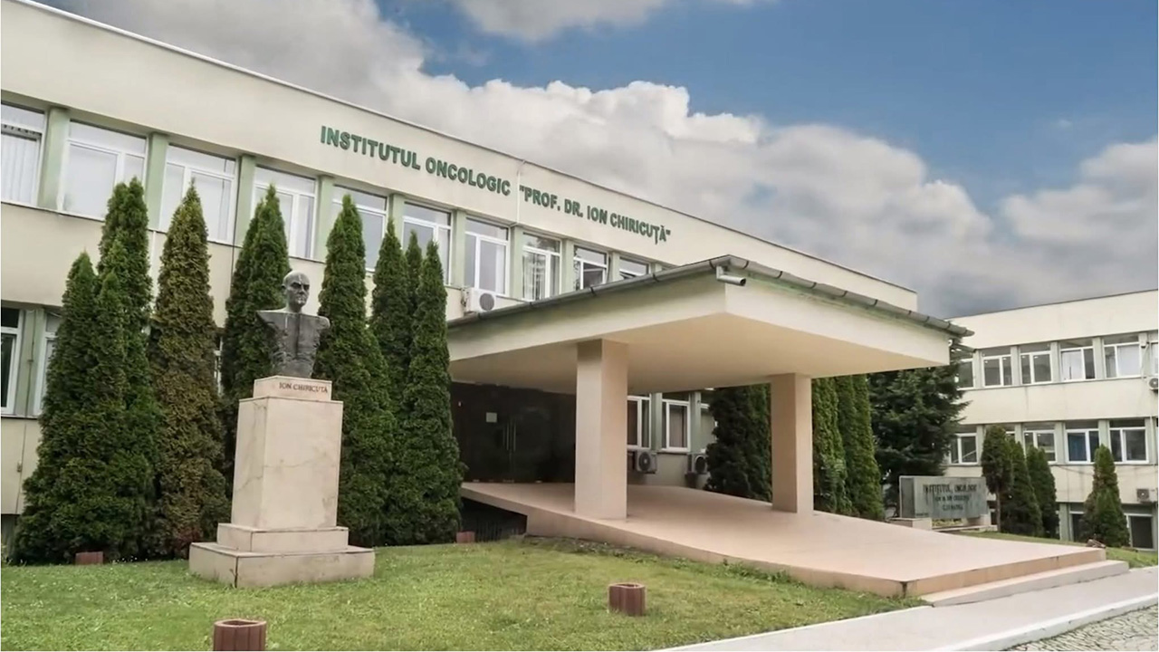 Oncology institute entrance with statue and trees