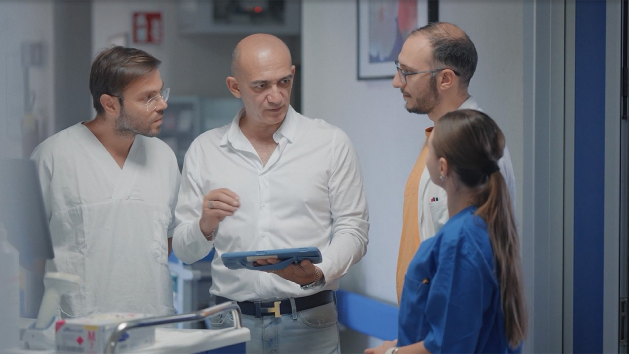 Medical team discussing patient data on Zebra tablet