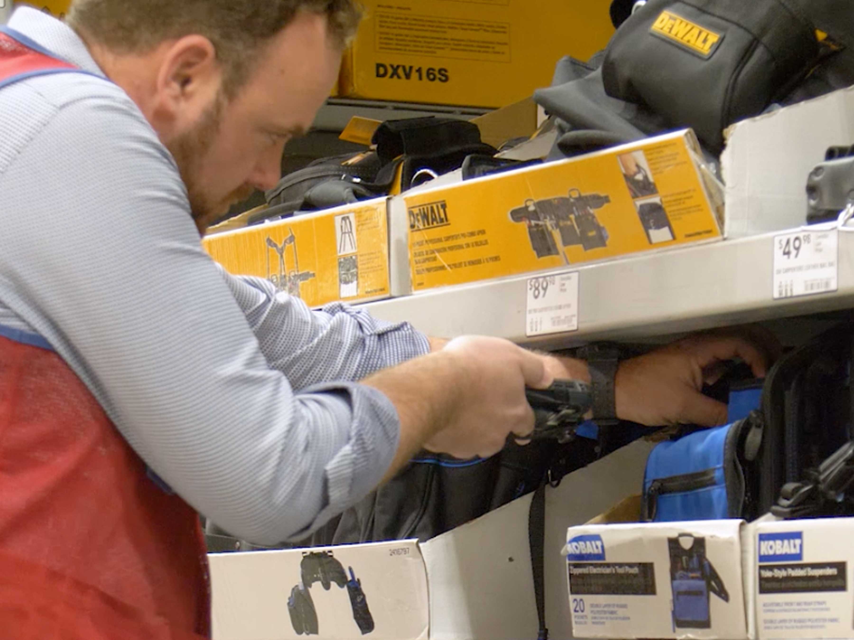 Worker scanning a blue bag with a handheld computer