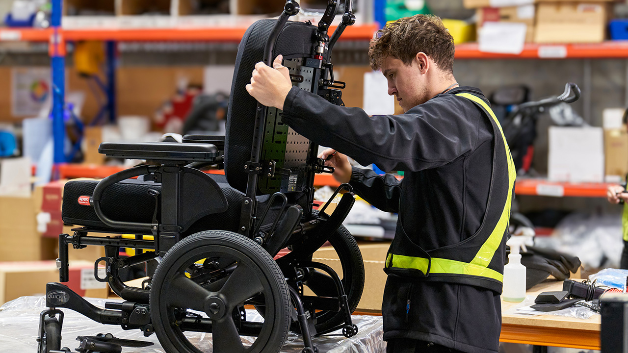 Medifab employee working on a wheelchair 