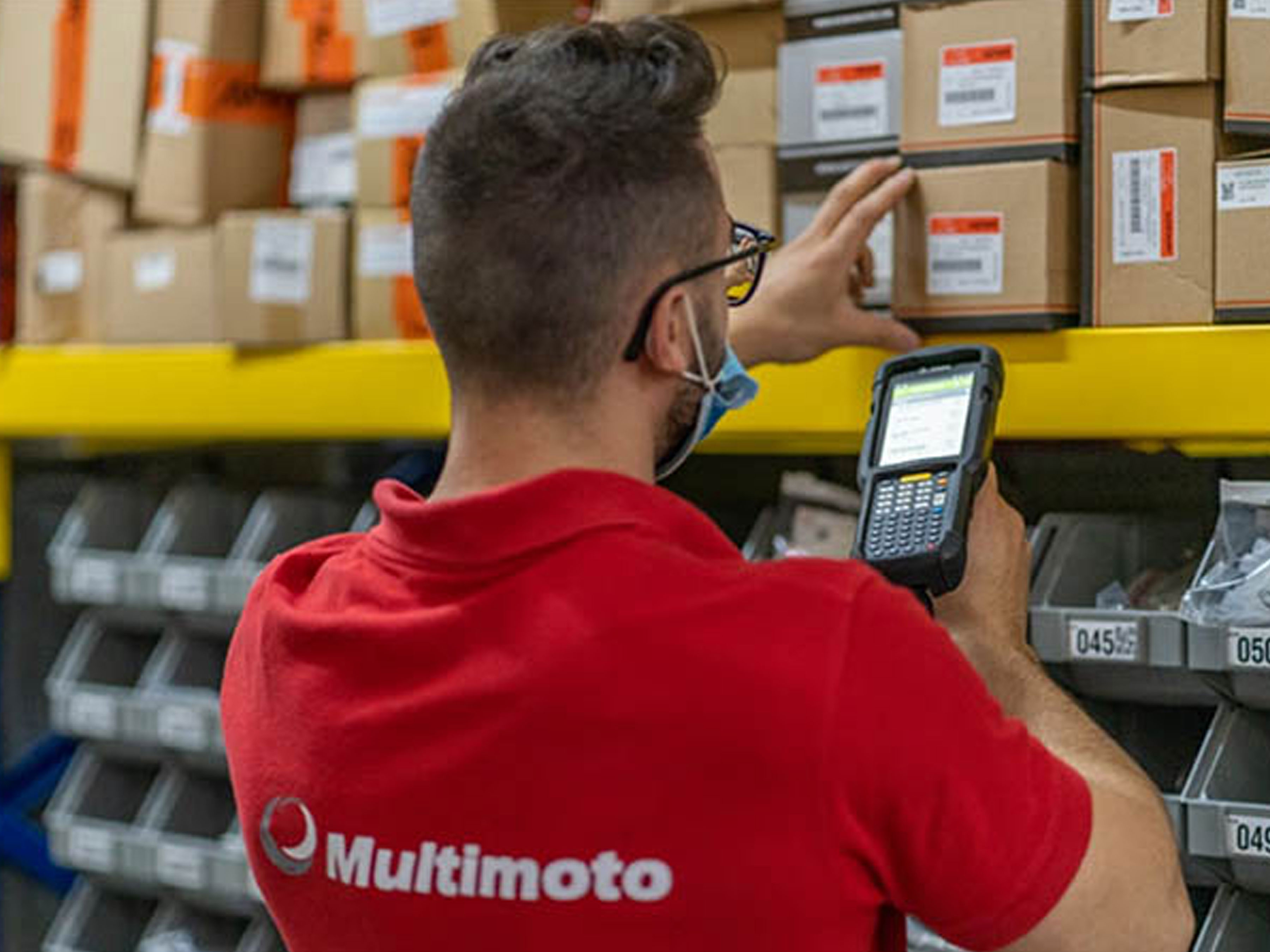 Multimoto employee scanning a box