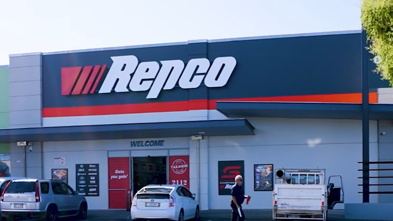 Repco automotive store exterior with parked vehicles