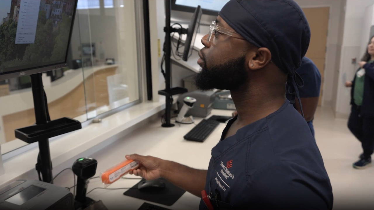 Healthcare worker scans item at hospital workstation
