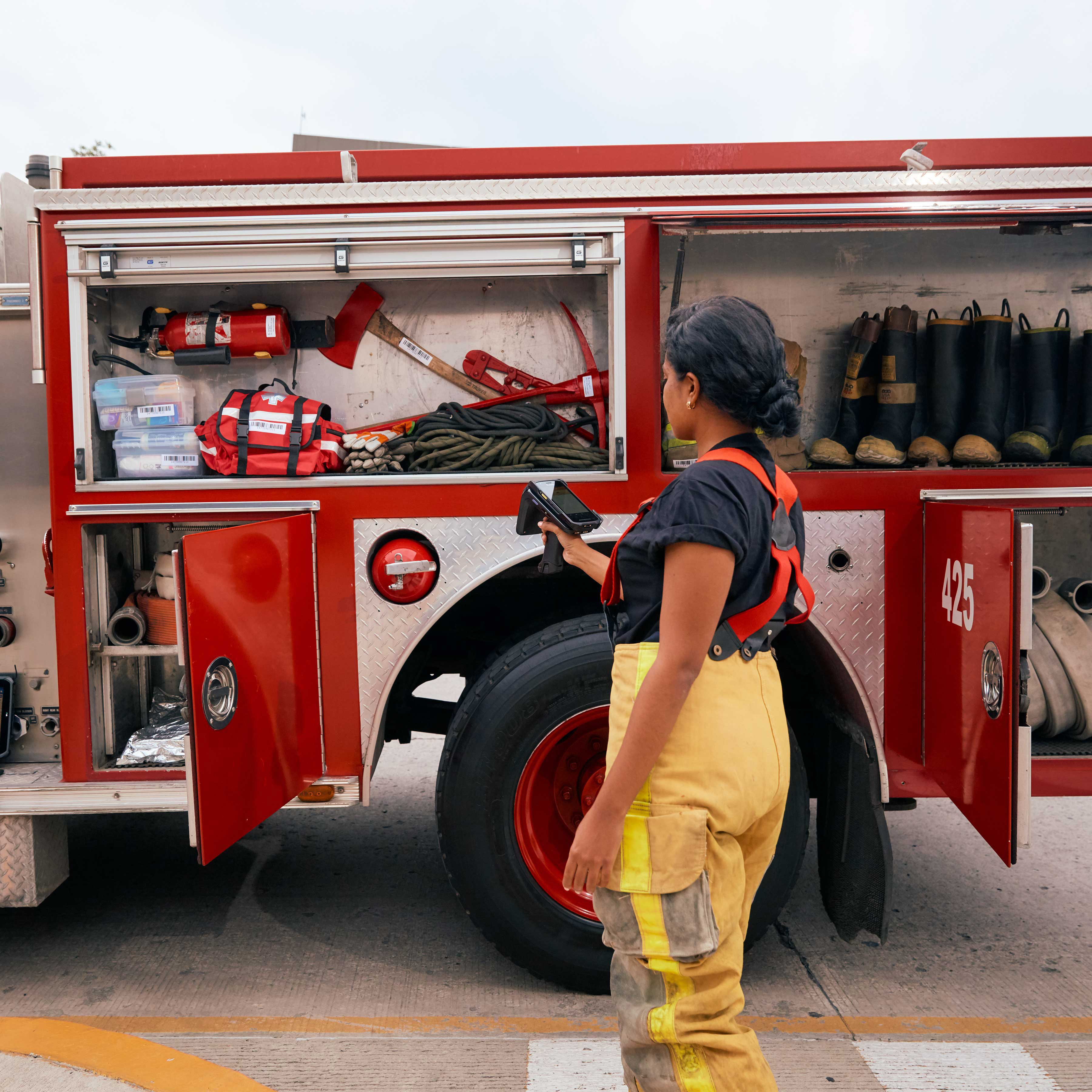 Firefighter using Zebra RFD40 and ET8x Tablet to check inventory.