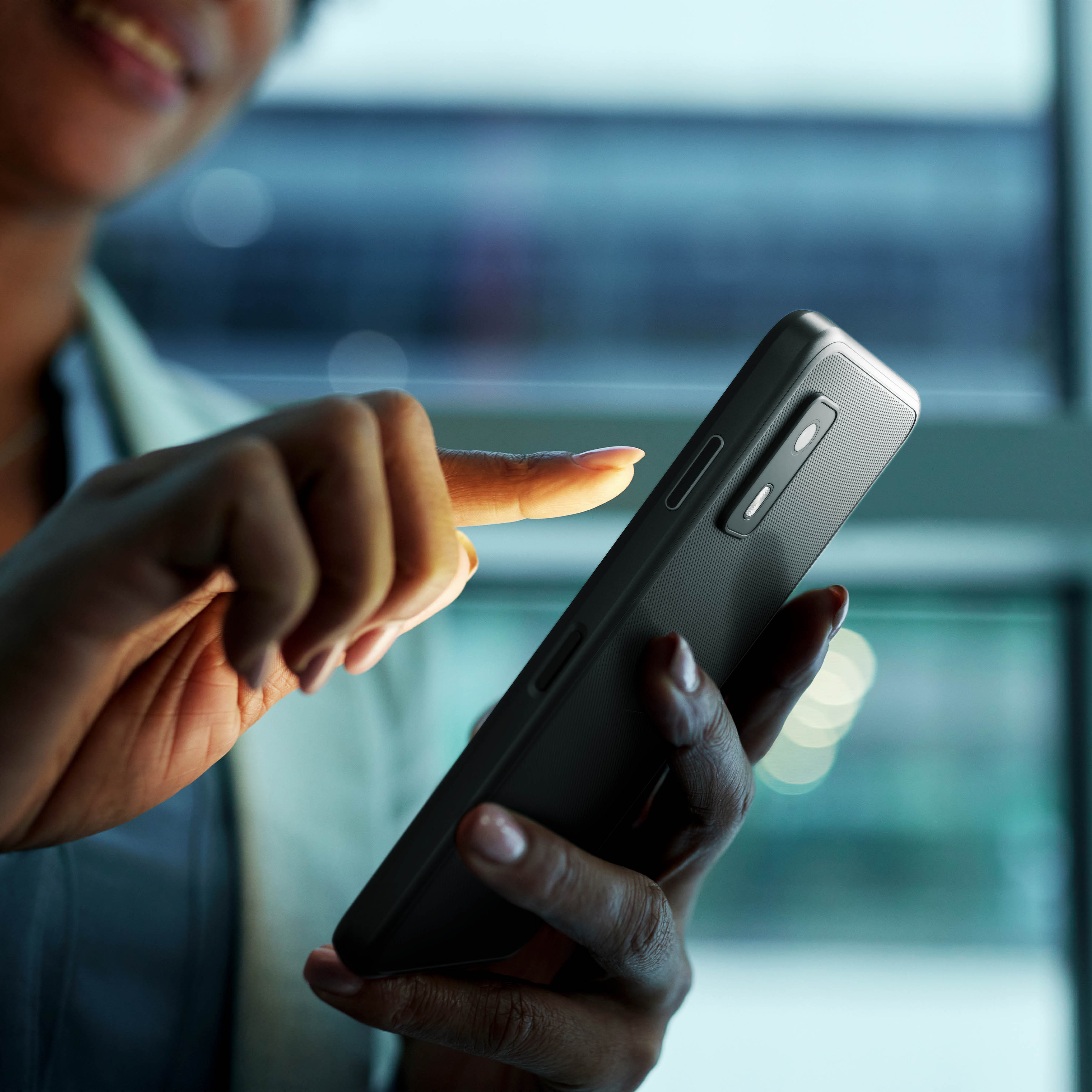 A healthcare professional using Zebra's Identity Guardian on an EM45 Enterprise Mobile computer, utilizing facial biometrics and secure multifactor authentication (MFA) to unlock clinical applications at the bedside while protecting personal user and corporate data
