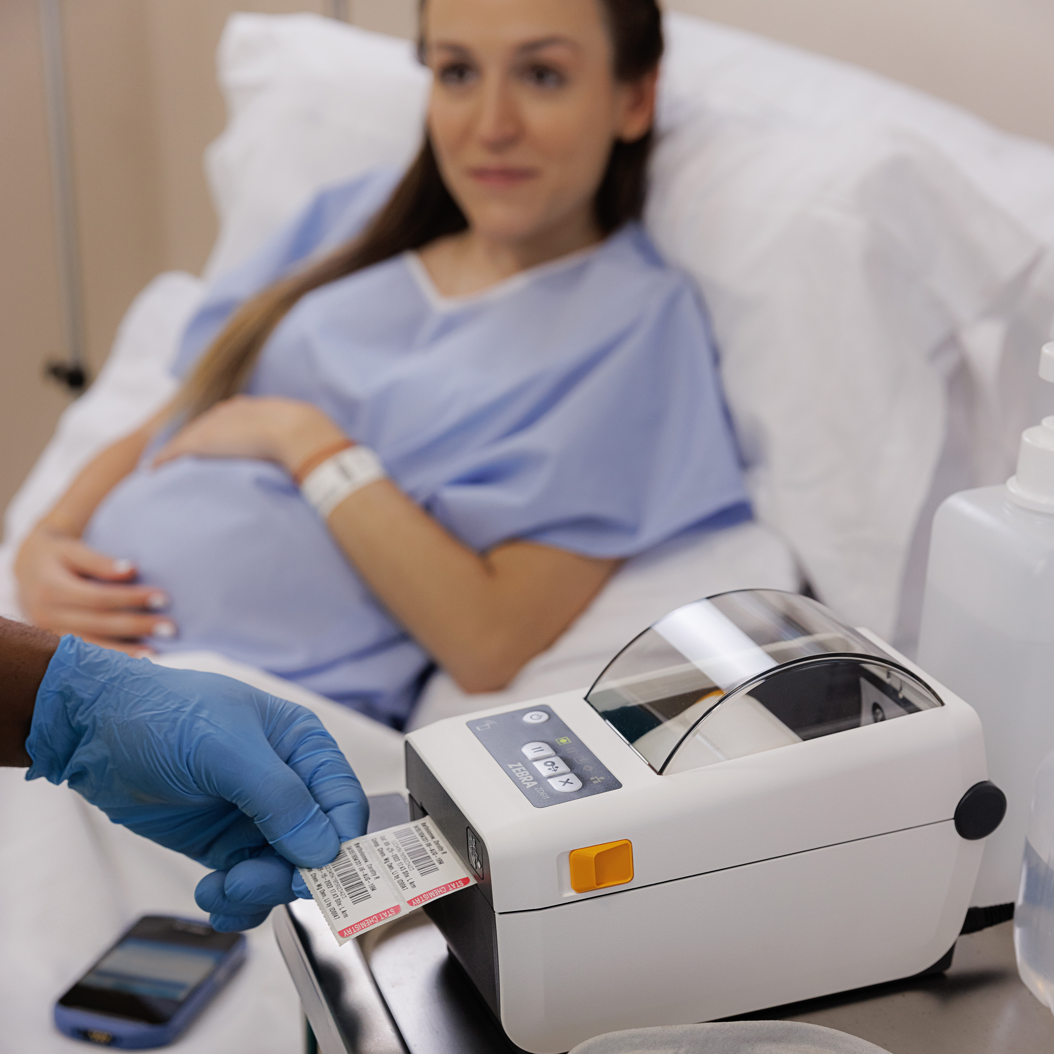 Healthcare provider printing label for blood panel on Zebra ZD611d-HC printer at patient bedside.