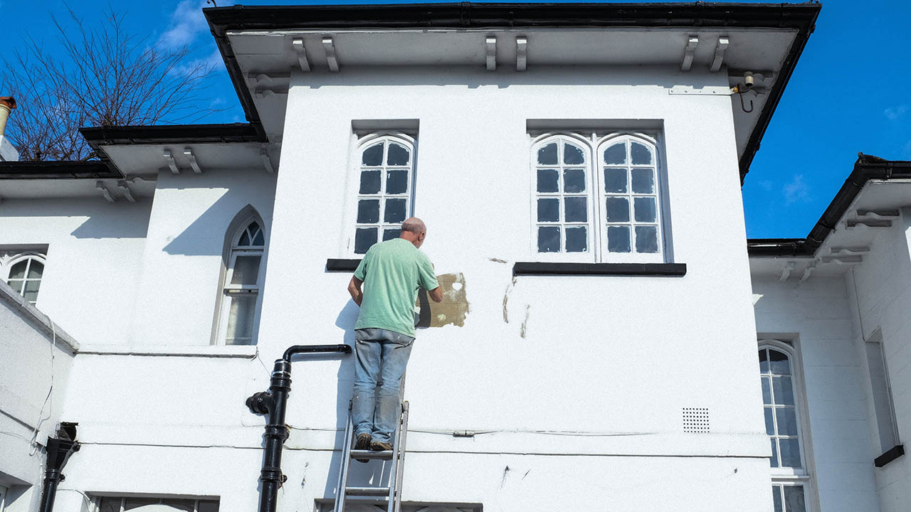 A man paints a house