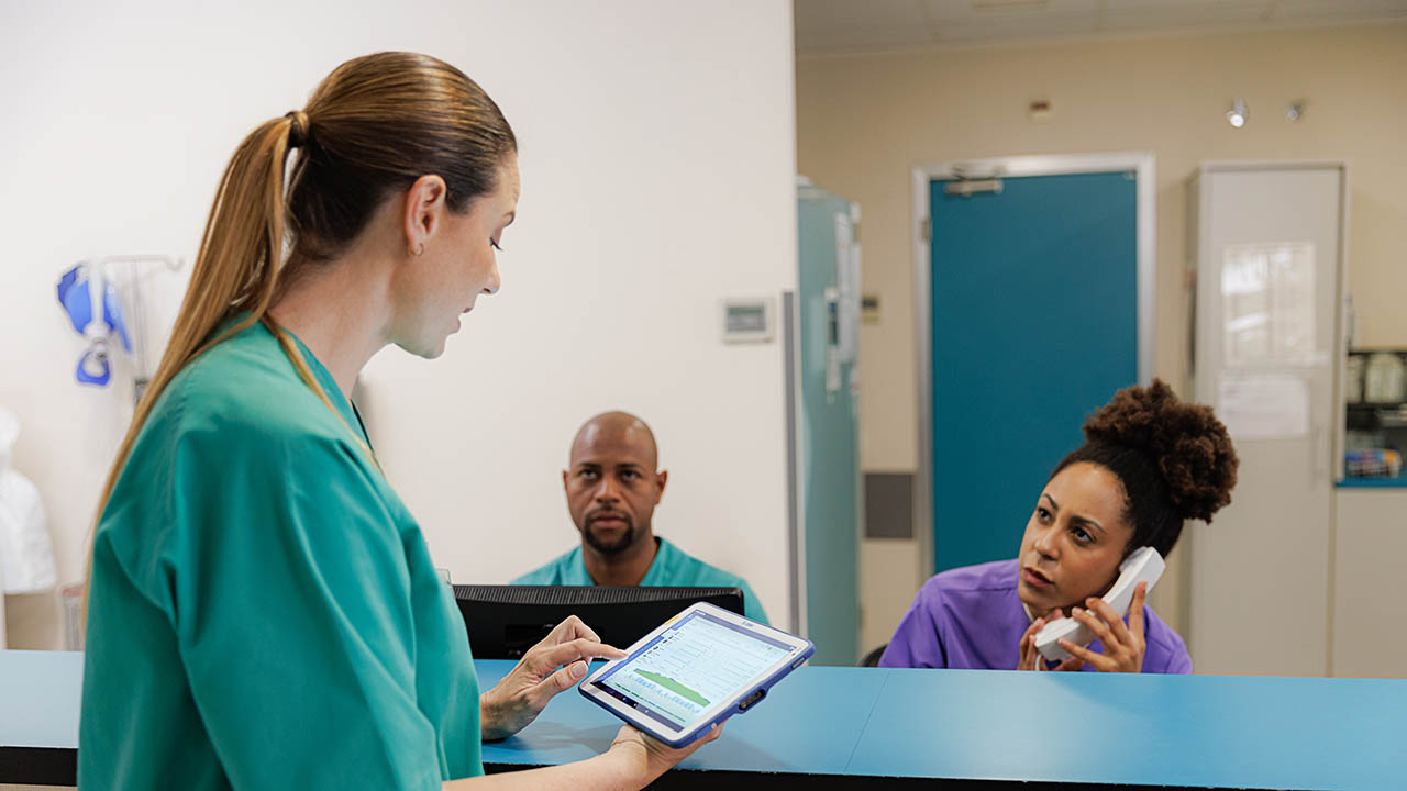 A nurse reviews the schedule on her healthcare tablet