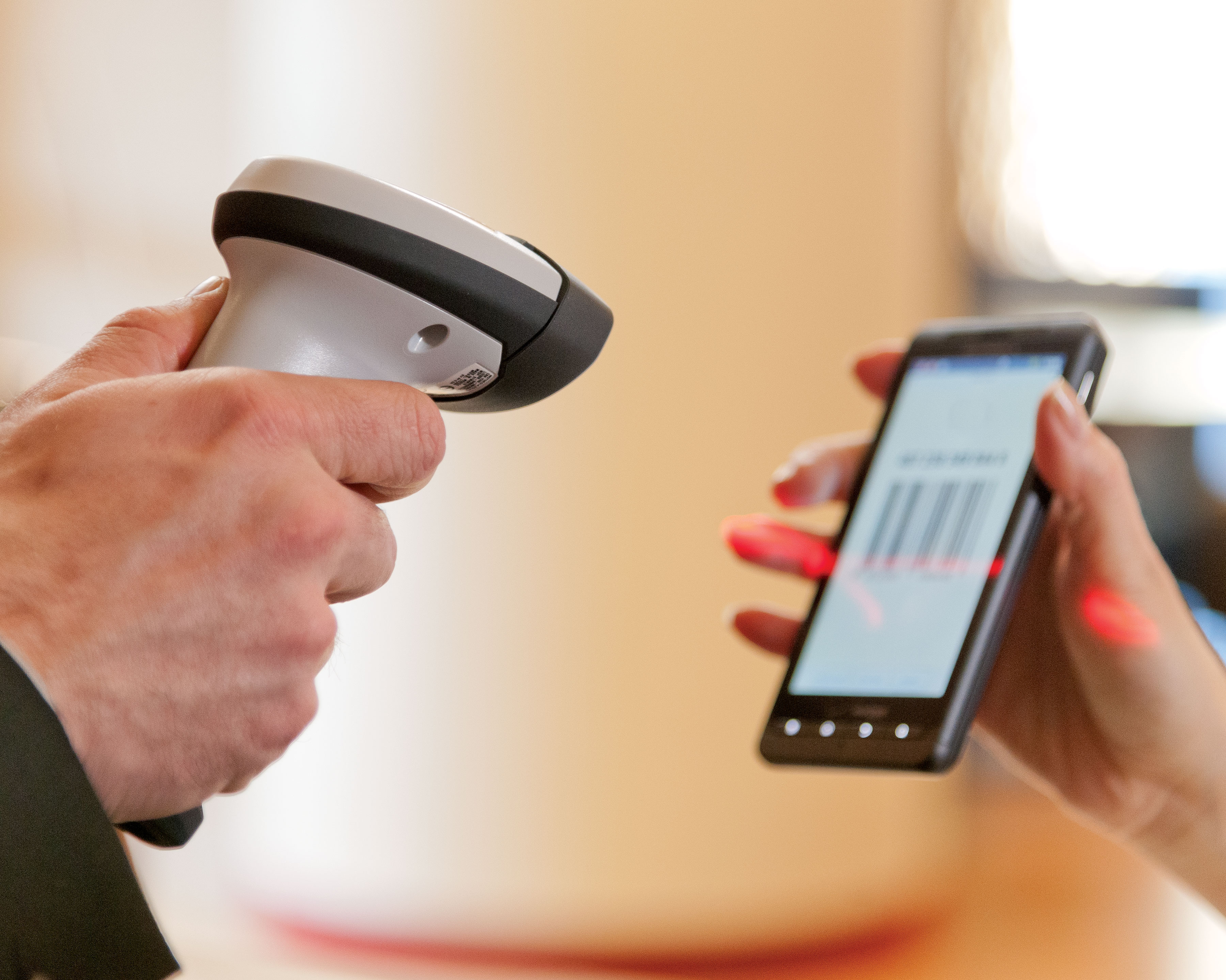 Zebra LI2208 barcode scanner for hospitality scans a barcode on a mobile phone screen