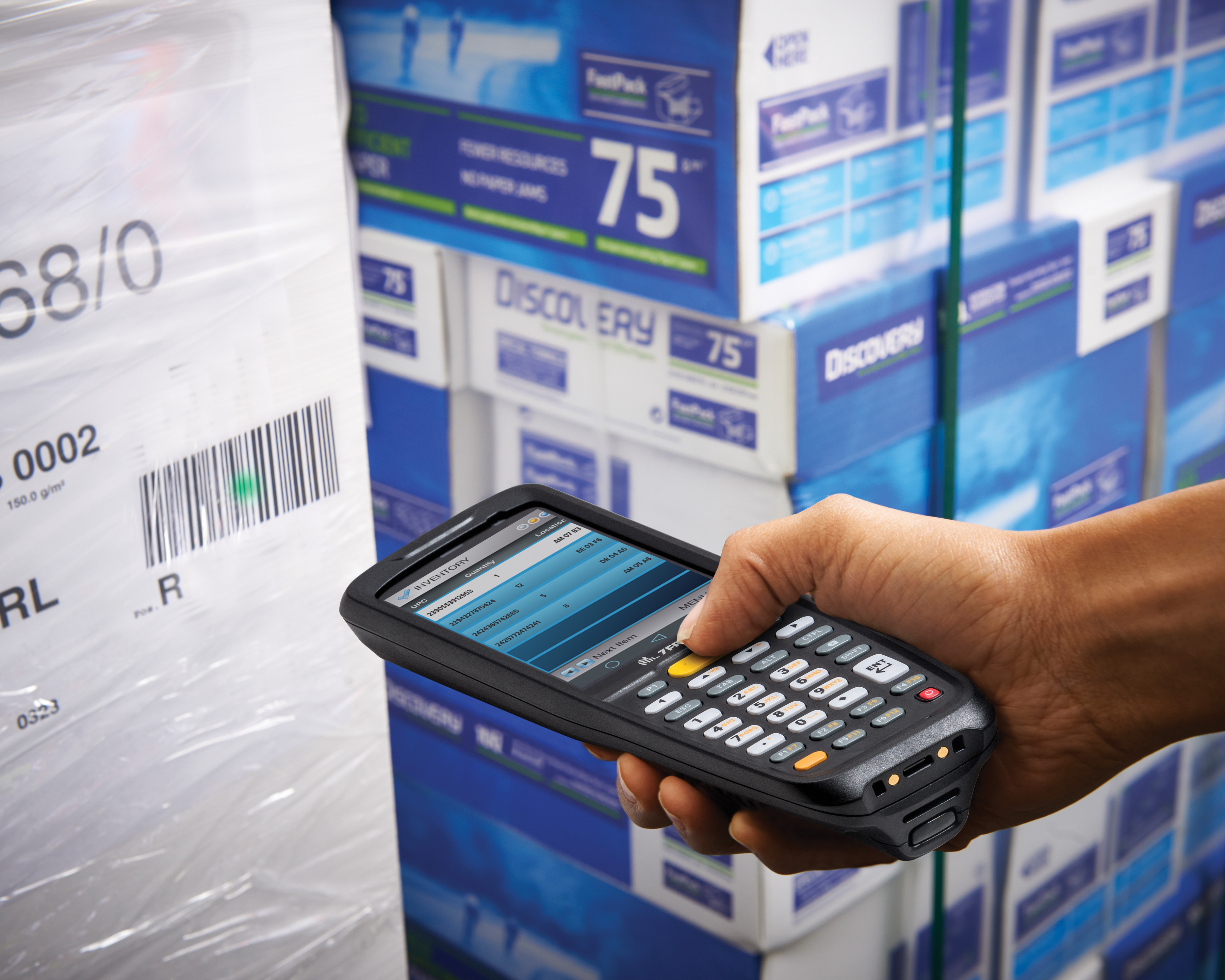 A person scanning a barcode with a Zebra MC9200 handheld computer