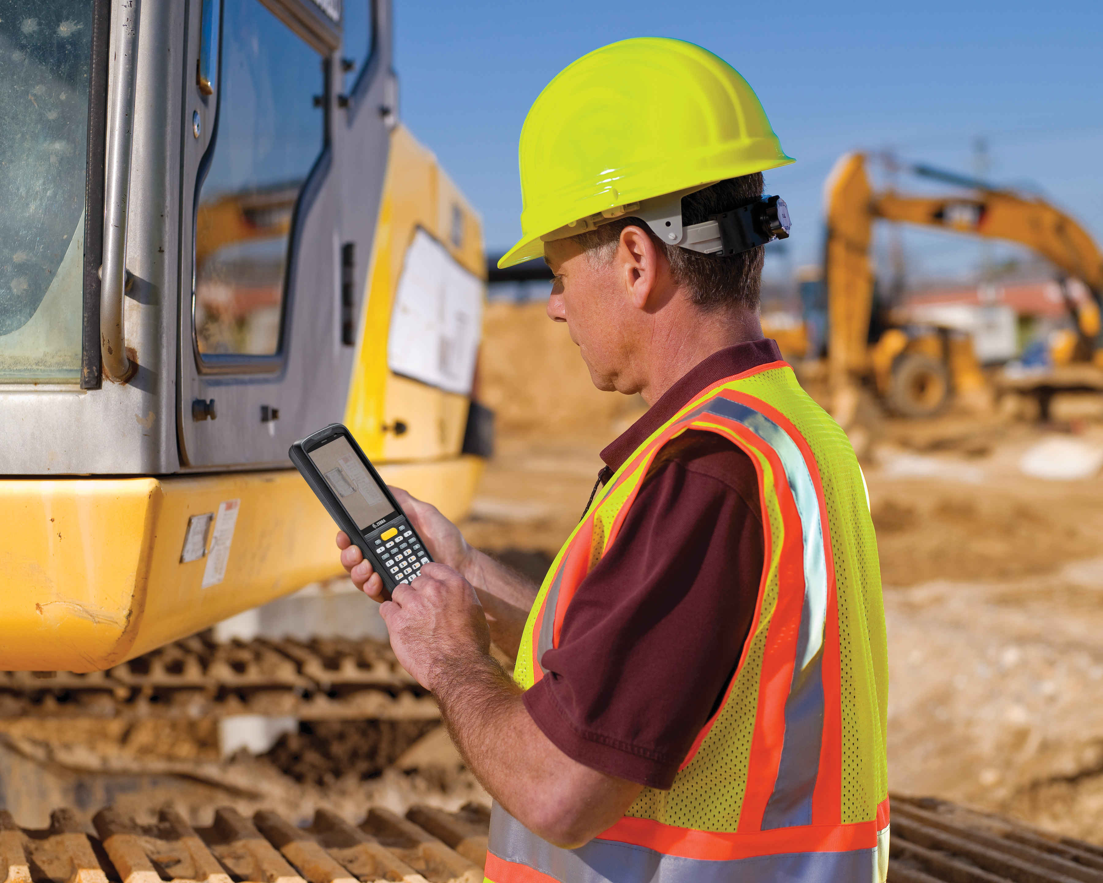 A construction worker using a Zebra MC9300 handheld computer 
