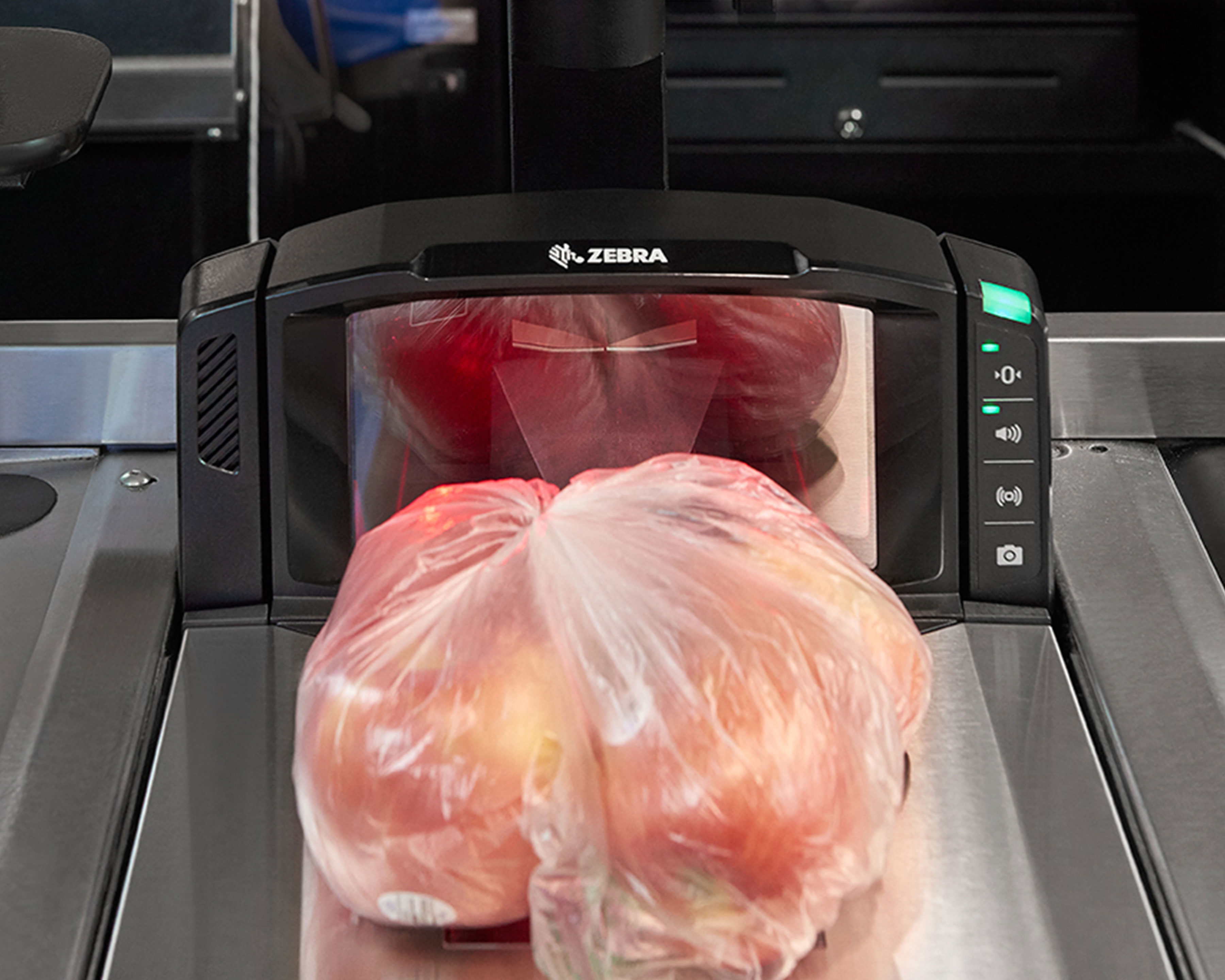Zebra MP7000 scale scanner at a grocery store measures the weight of apples in a plastic bag