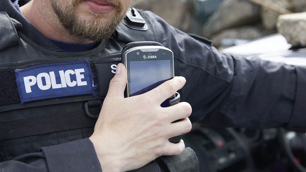 A Zebra mobile computer strapped to a police officer's vest