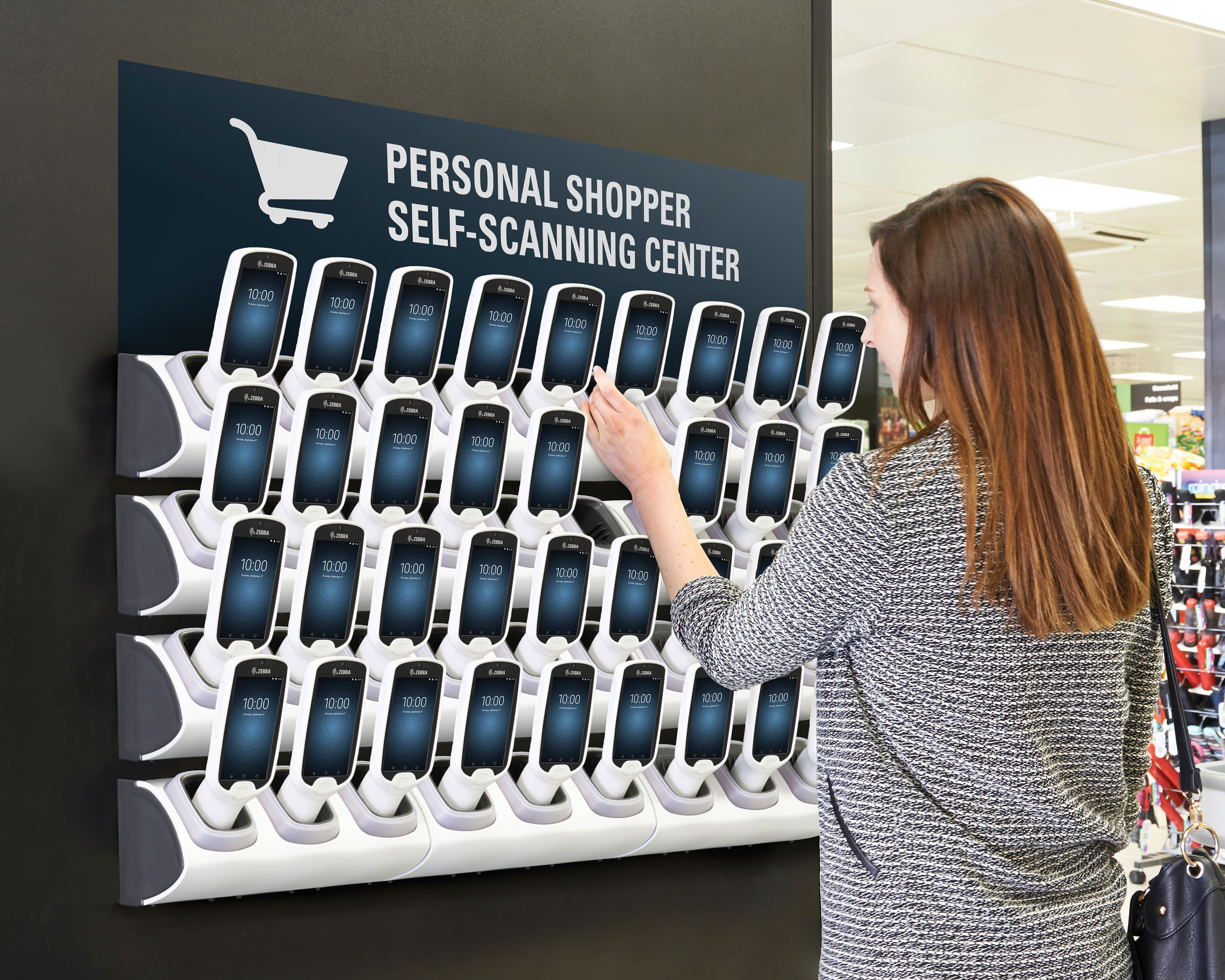 Retail customer picking up a Zebra PS20 personal shopper handheld mobile computer at the self-scanning center