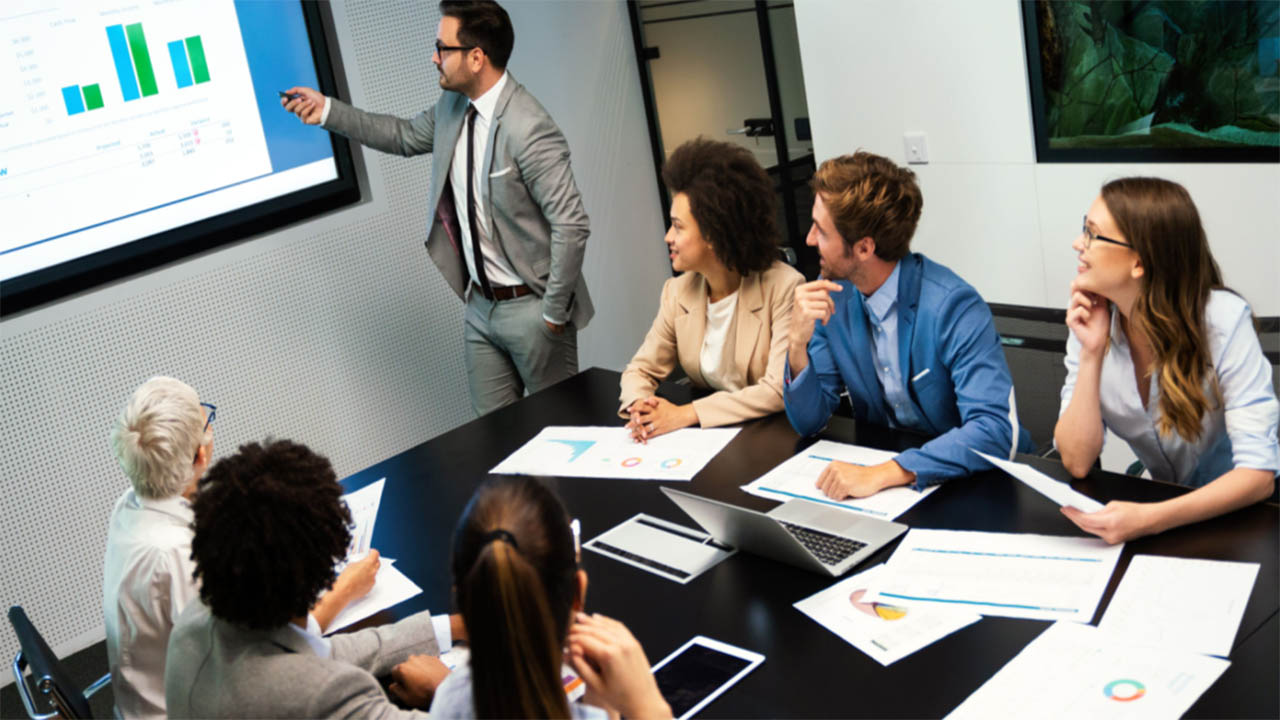 Retail decision-makers review charts on a screen