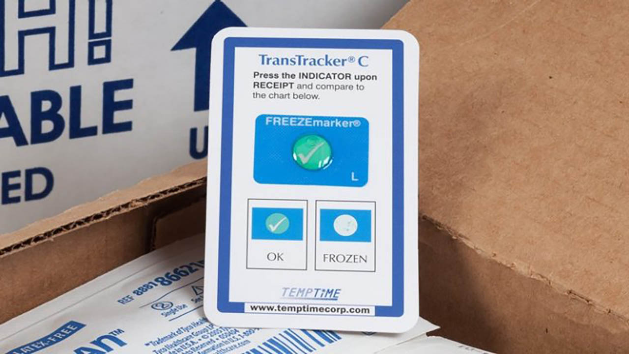 A Zebra Transtracker temperature indicator sits in a box being prepared for cold chain shipment