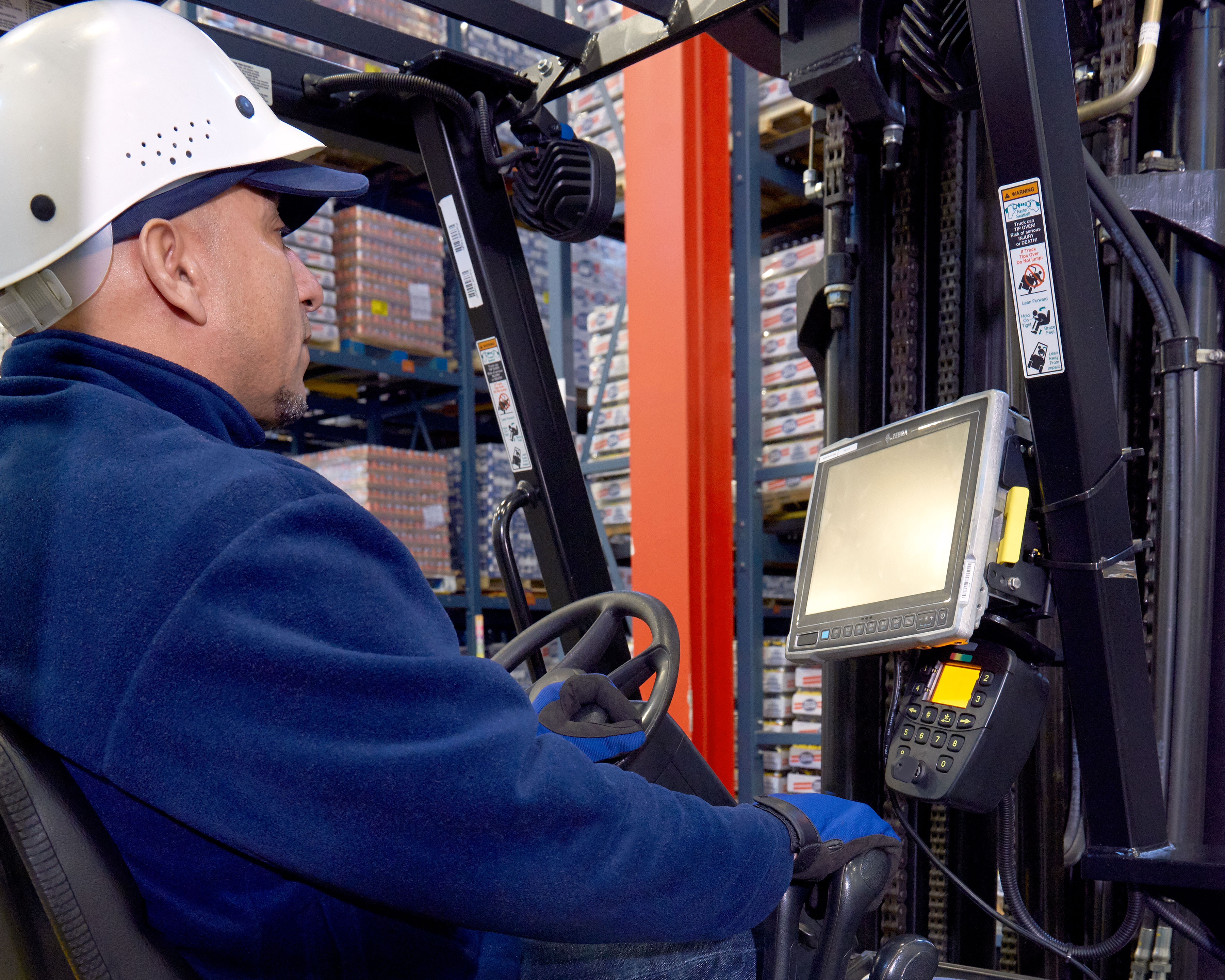 Driver uses a Zebra mobile computer mounted to a warehouse forklift truck