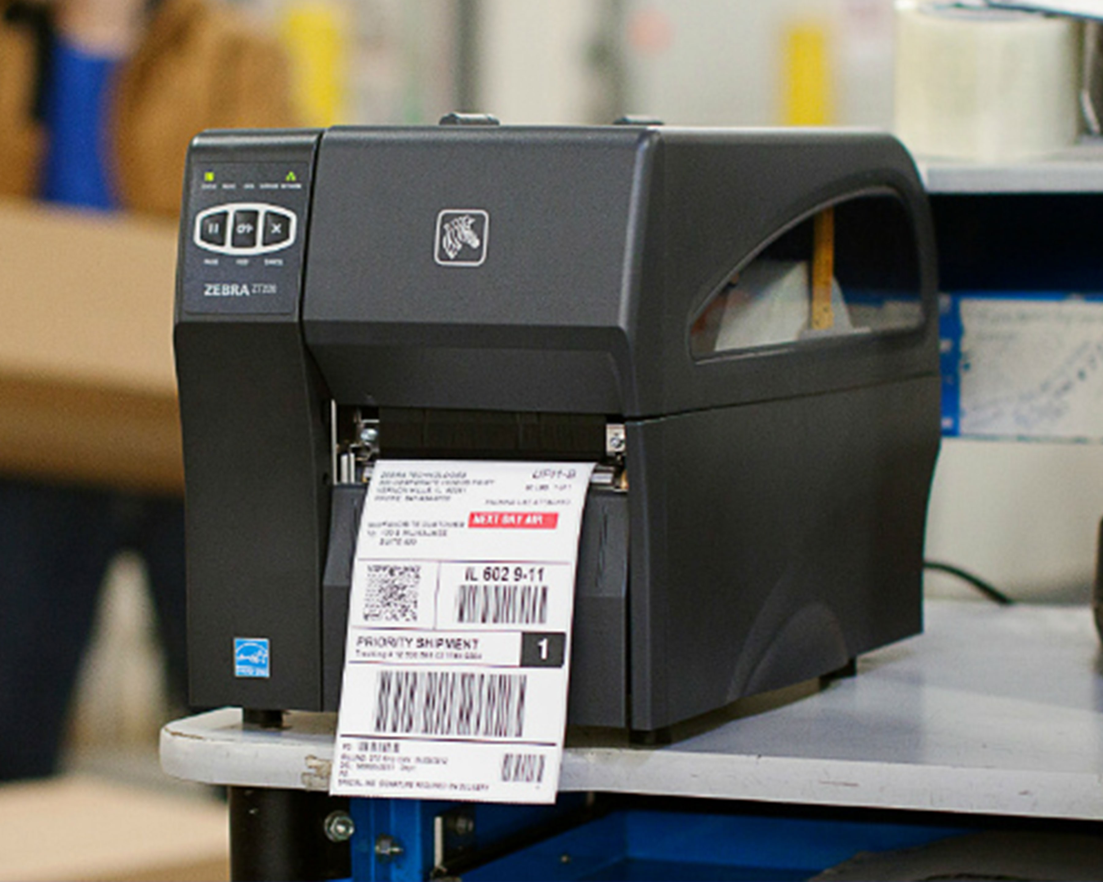 Zebra ZT200 industrial printer with IQ Color direct-thermal ink technology prints out a colored retail shipping label