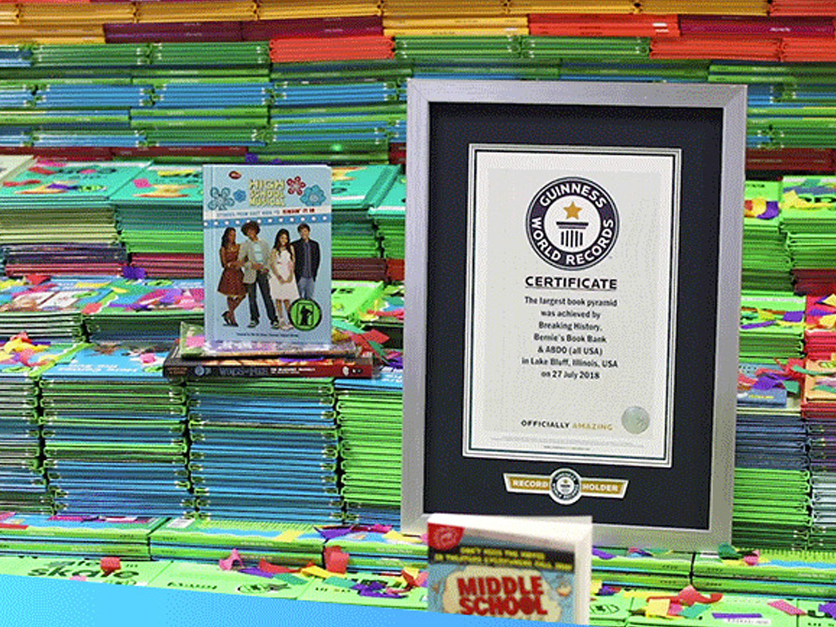 Bernie's Book Bank Guinness World Record Certificate in a frame on a pile of books
