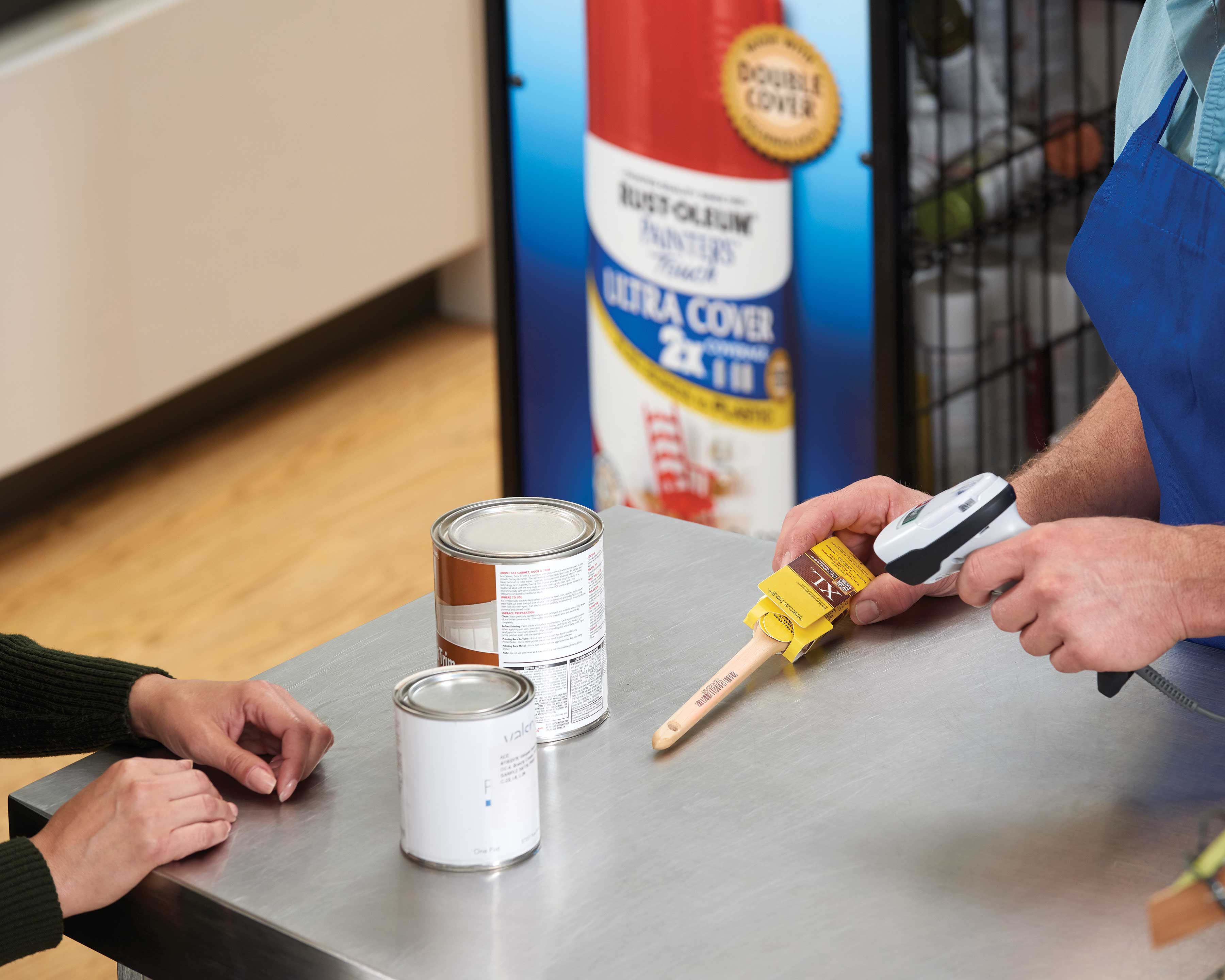 Employee scanning paint supplies for a customer