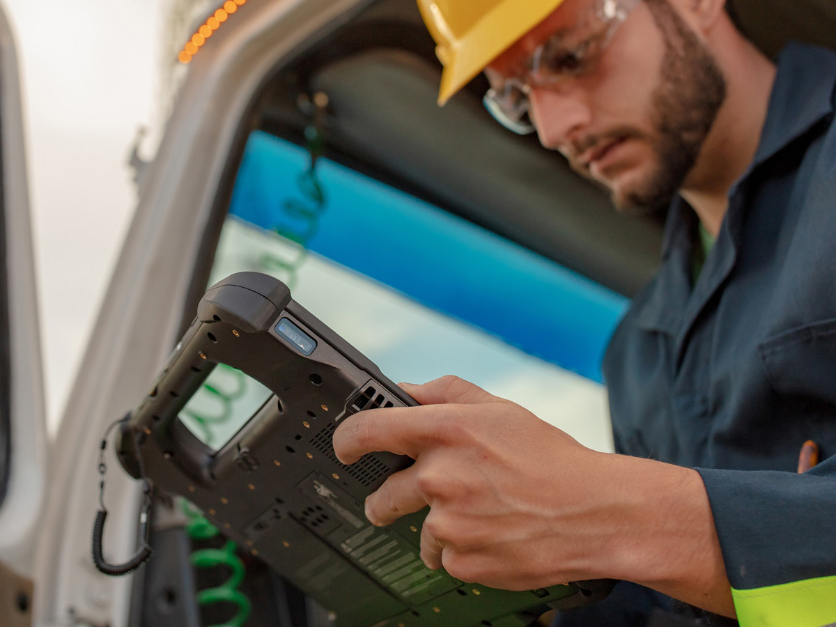 Utilities workers holding a zebra tablet