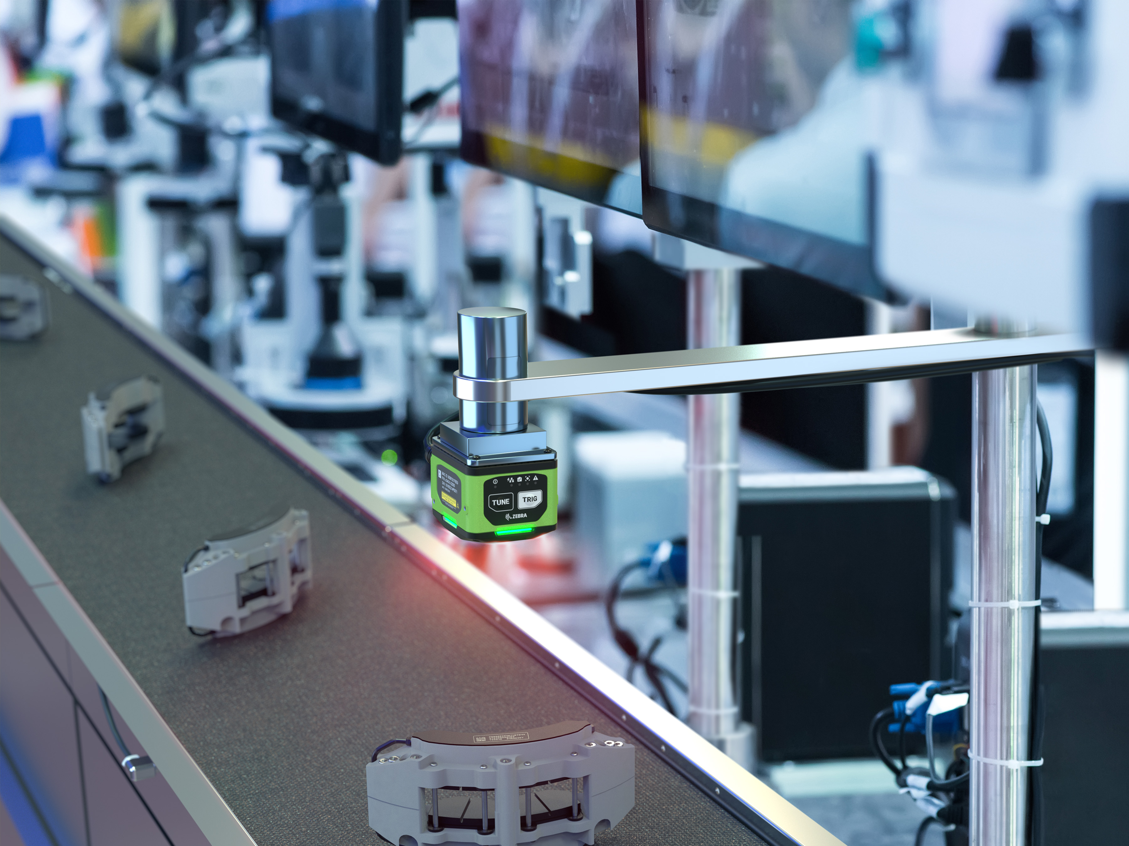 A machine vision camera is mounted on a metal arm and is pointed towards the production line. The camera is capturing high-resolution images of the products being produced on the line. The purpose of these images is to inspect the quality of the products and ensure that they meet the required specifications. The camera's advanced image processing algorithms can detect even the slightest defects or anomalies in the products, allowing for quick and efficient quality control.