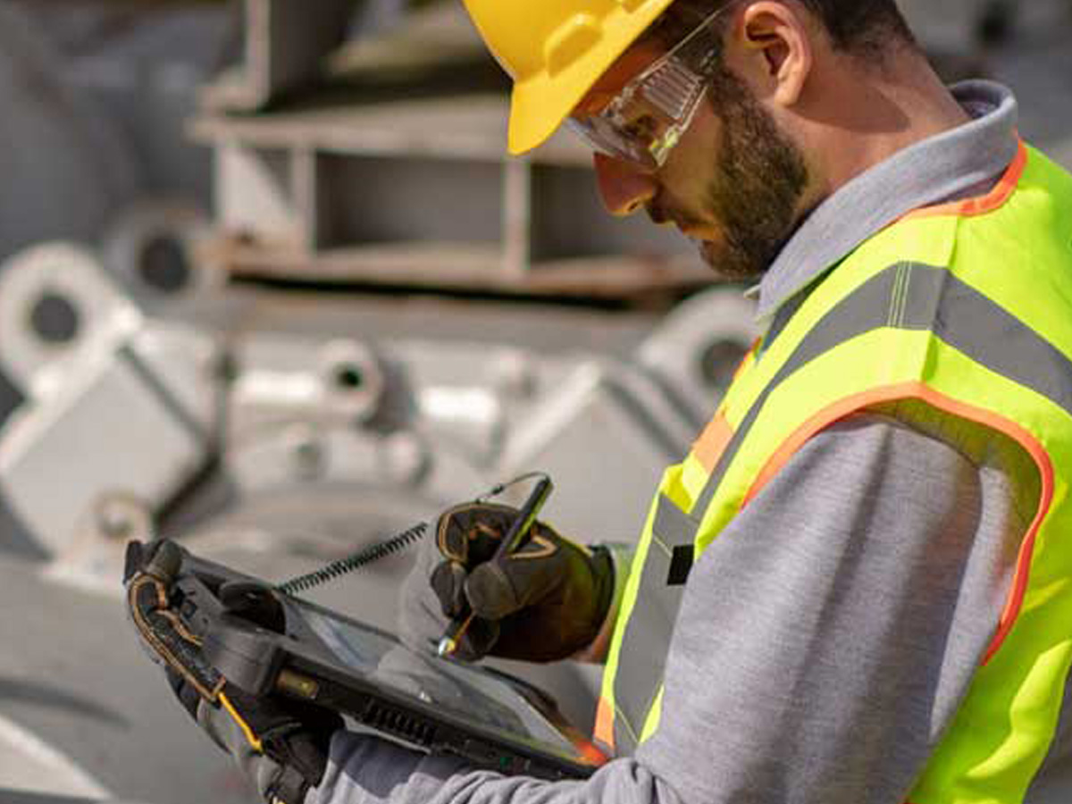 Utilities Worker using a stylus on a zebra tablet