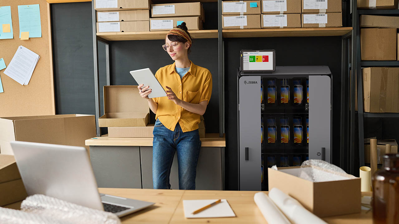 Warehouse worker using digital tablet to check track number of parcels while standing in storage room