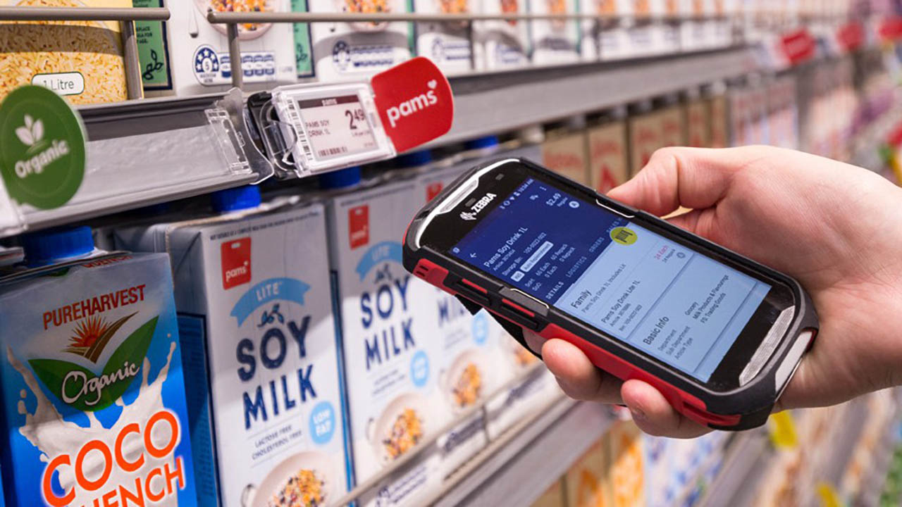 A Zebra handheld mobile computer is used to check a shelf edge label at a Foodstuffs store