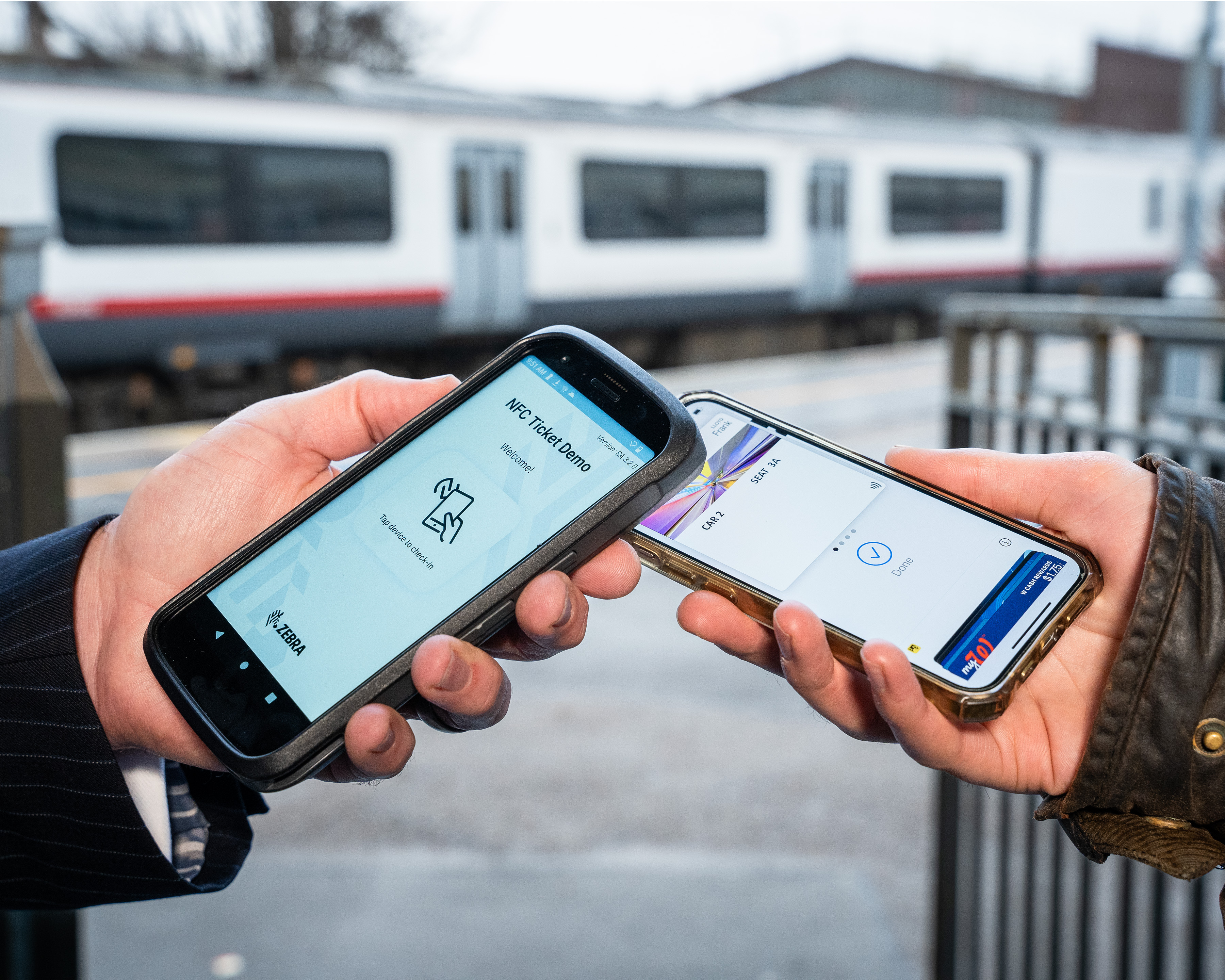 Photography of two people transferring a ticket via NFC using a TC22 - TC27