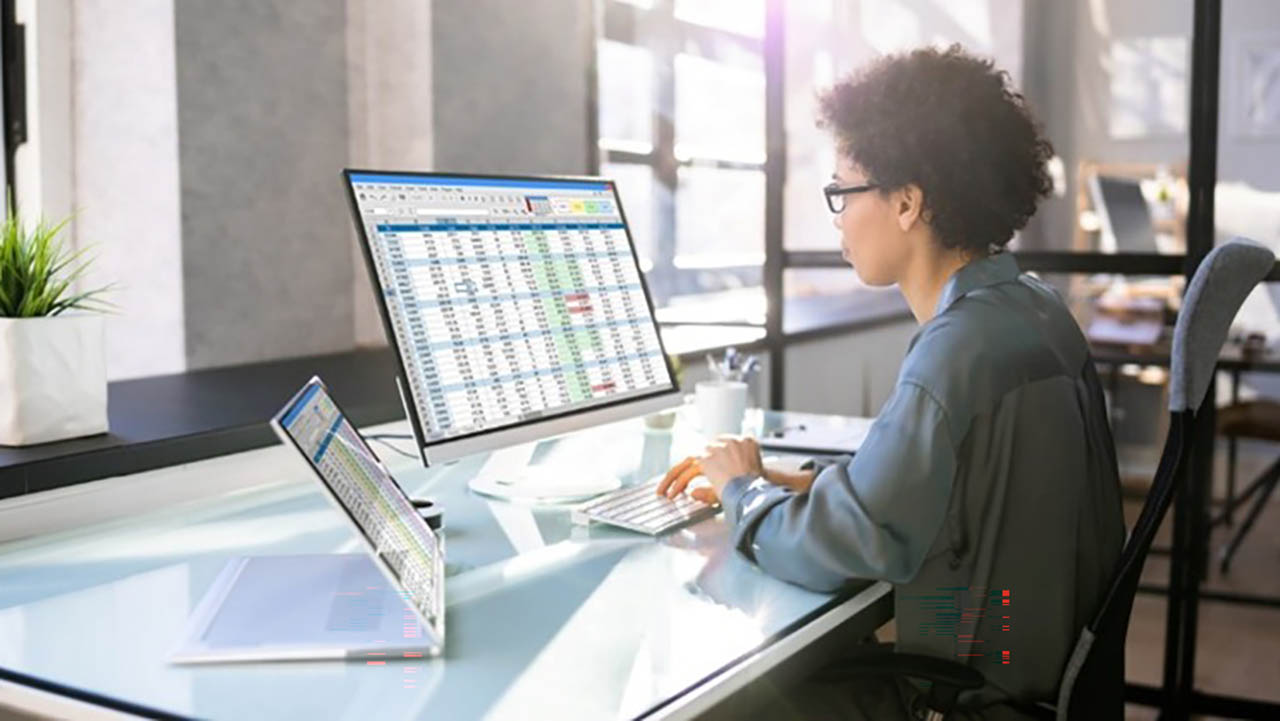 A person sits at their desk typing