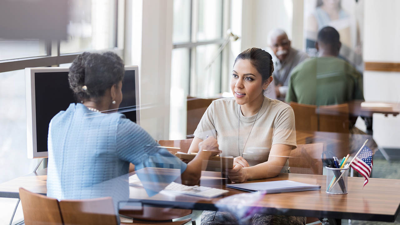 A bank associate assists a customer at her desk