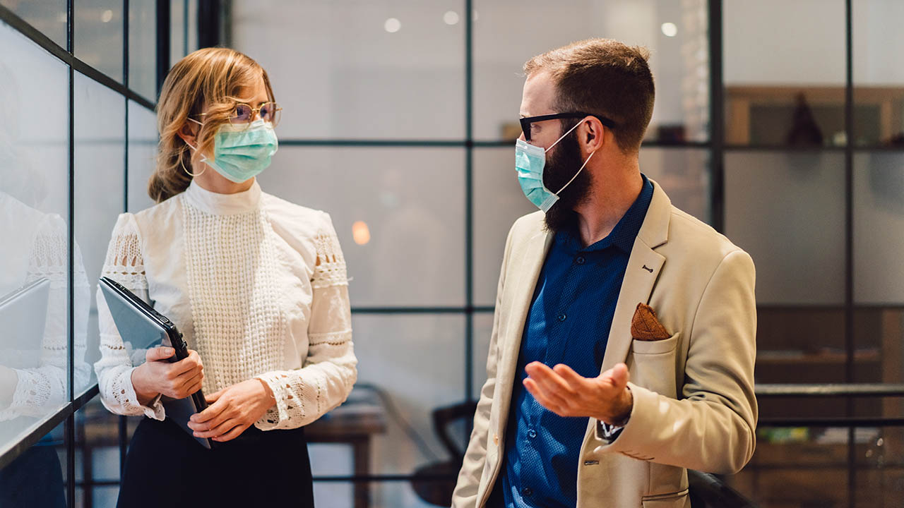 A financial consultant meets with a client in a bank branch