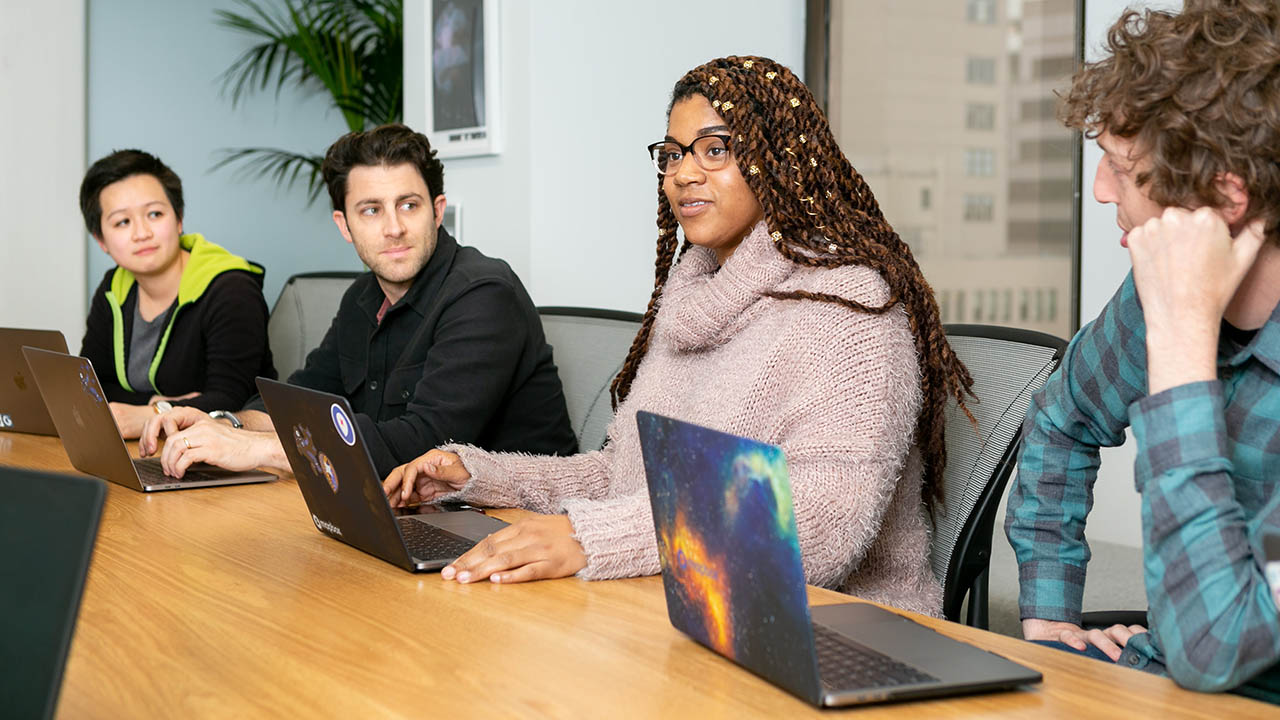 A team collaborates at a conference room table