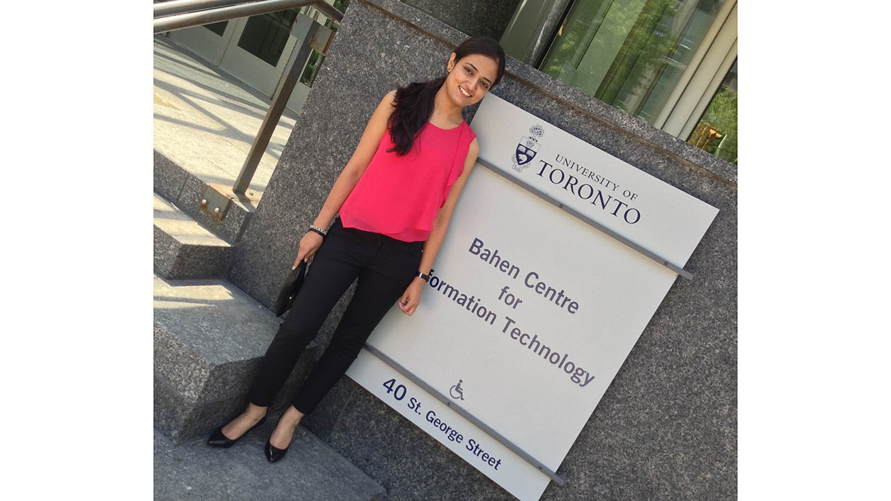 Jagdeep Rangi, a software engineer on Zebra's robotics automation team, stands in front of a University of Toronto sign